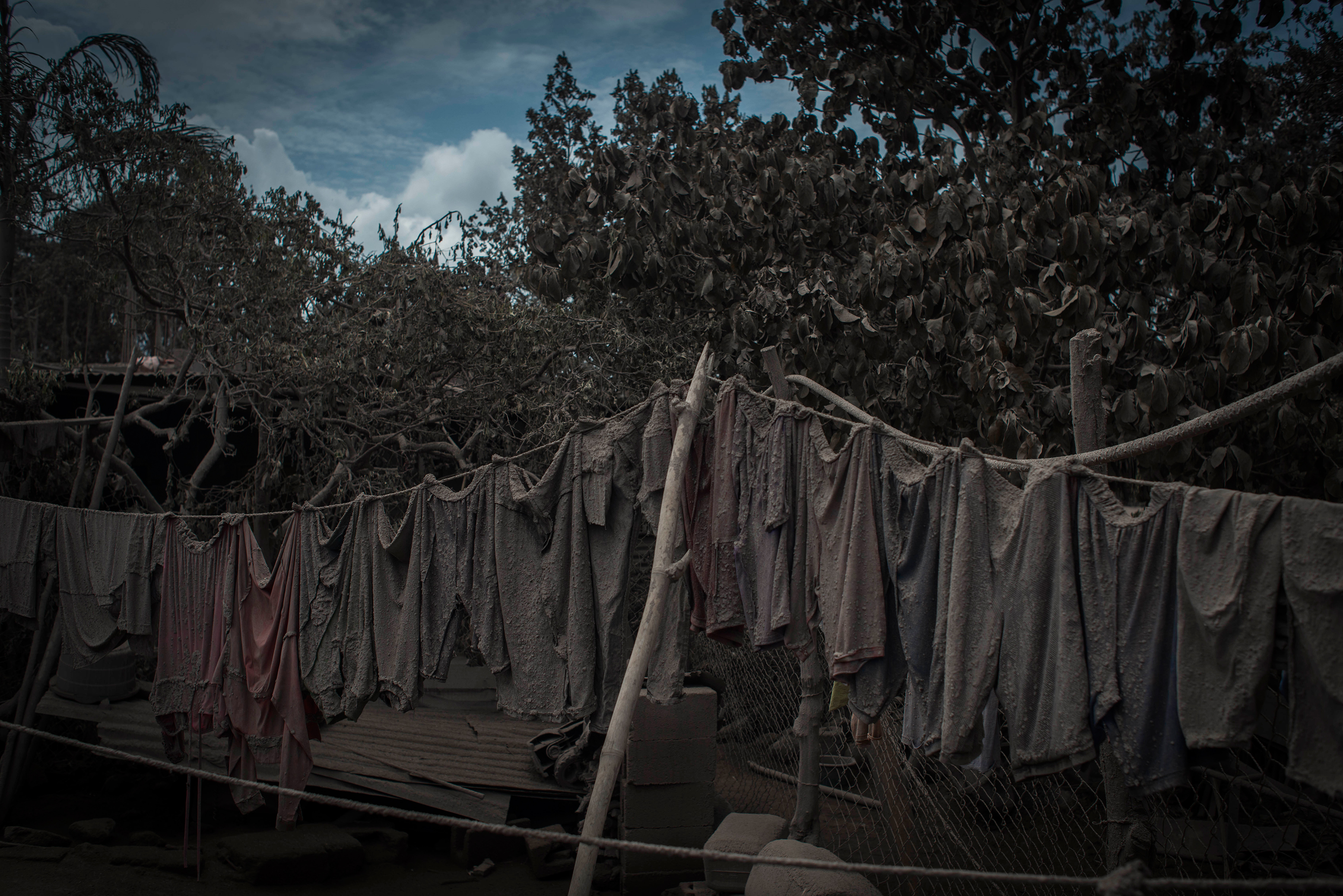 An ash-covered clothesline hangs outside a home in San Miguel Los Lotes on June 5. (Daniele Volpe)