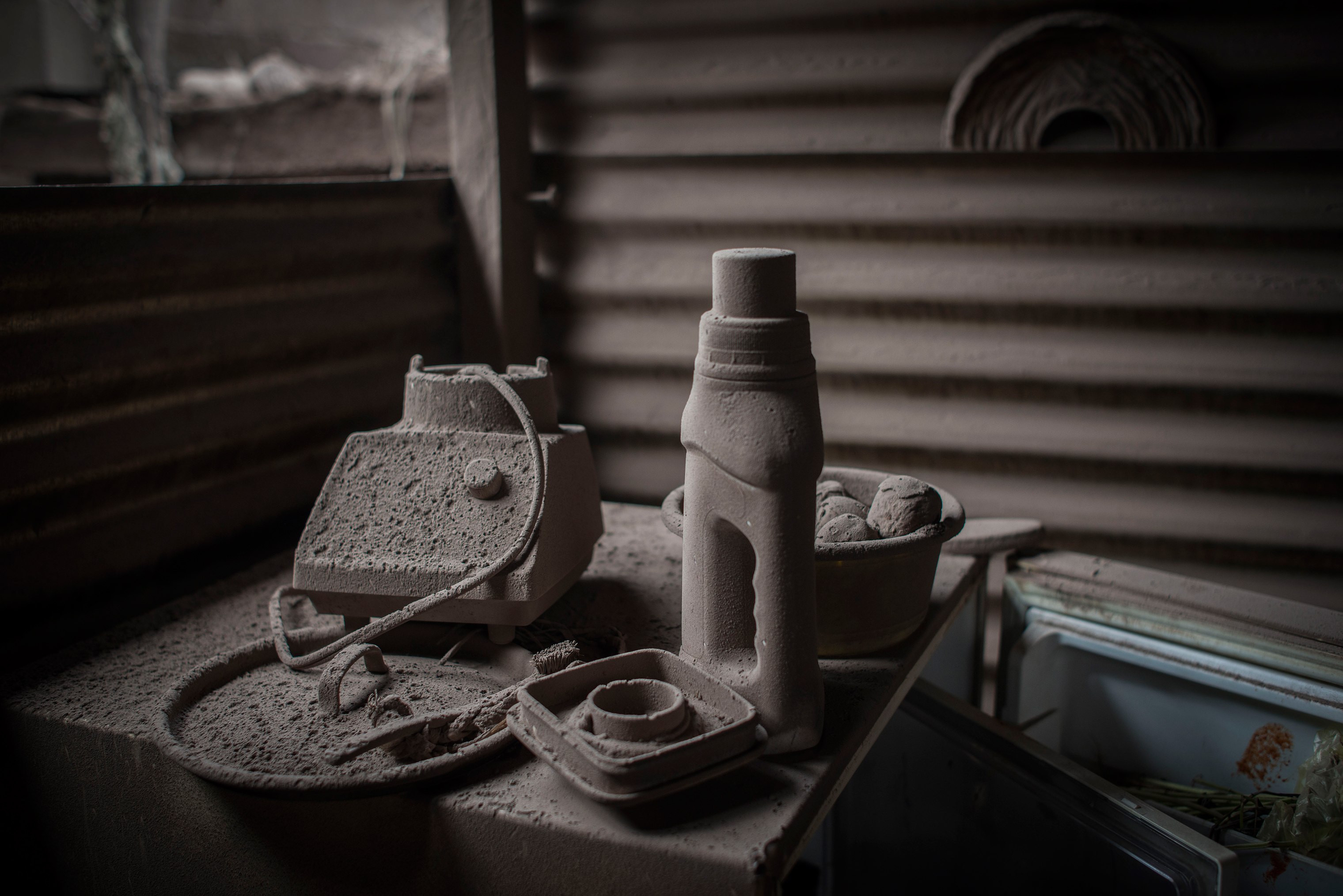 Ash-covered home goods, including parts of a blender, in an abandoned home in San Miguel Los Lotes on June 5. (Daniele Volpe)