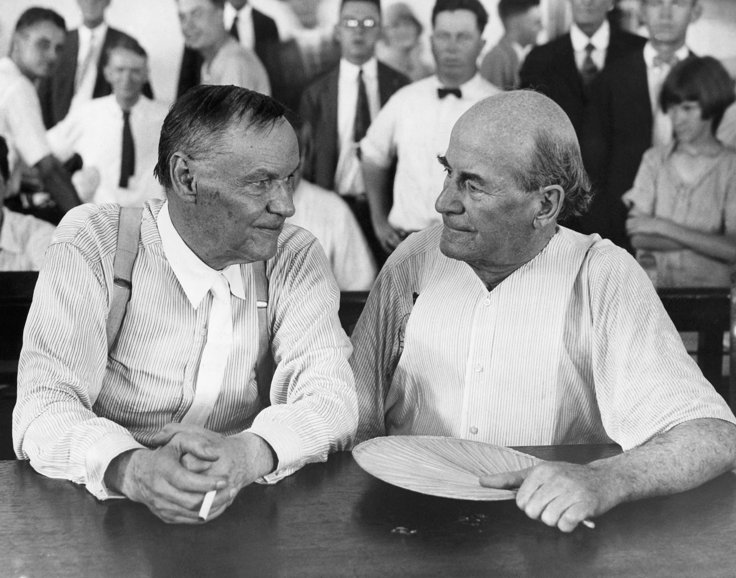 Clarence Darrow, a famous Chicago lawyer, and William Jennings Bryan, defender of Fundamentalism, have a chat in a courtroom during the Scopes evolution trial in 1925. (Bettmann/Getty Images)