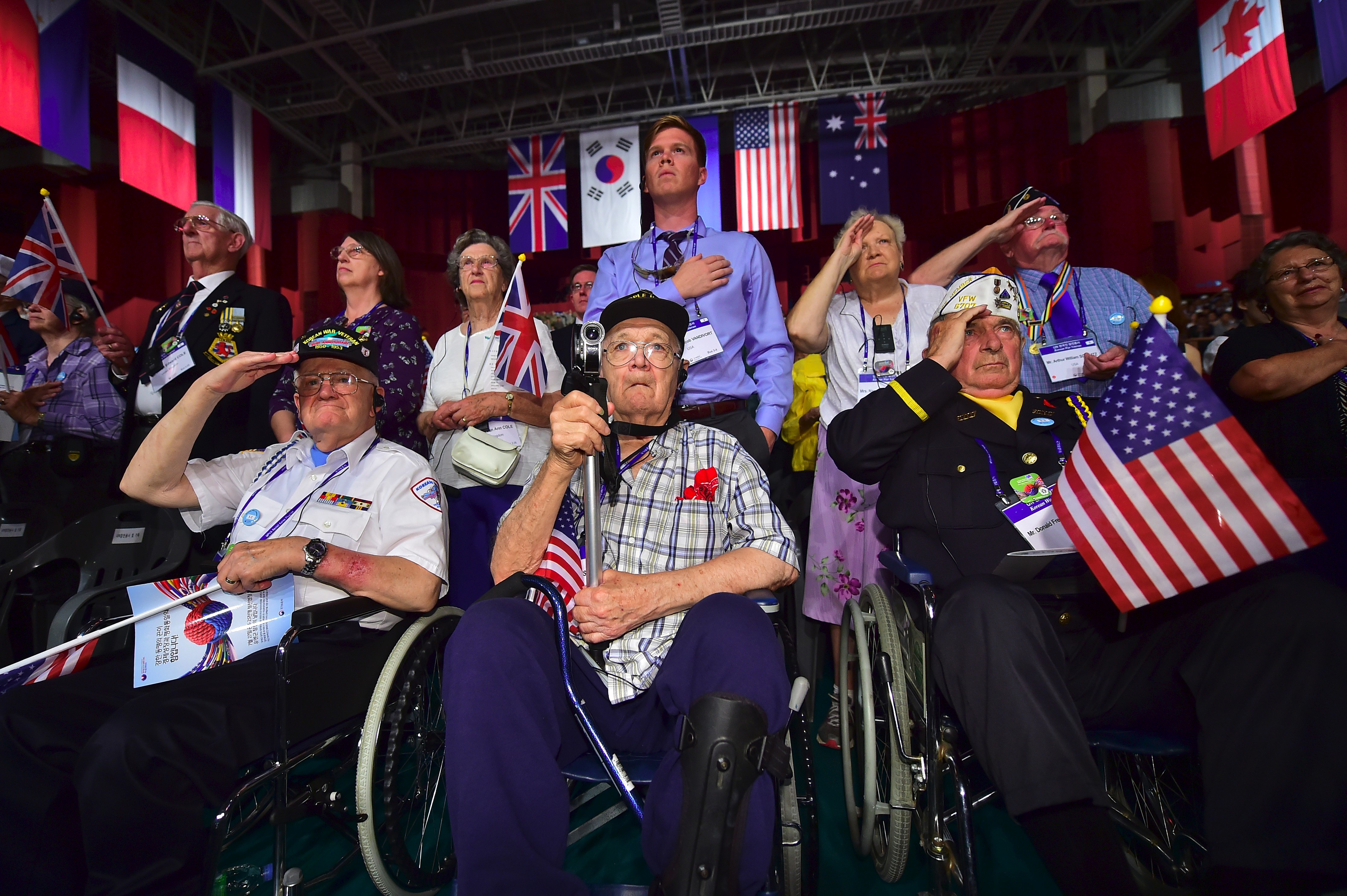 Invited US veterans, who fought in the Korean War under the United Nations flag, and their family members salute during a ceremony to commemorate the 63rd anniversary of the Korean War Armistice Agreement in Seoul on July 27, 2016. (JUNG YEON-JE—AFP/Getty Images)