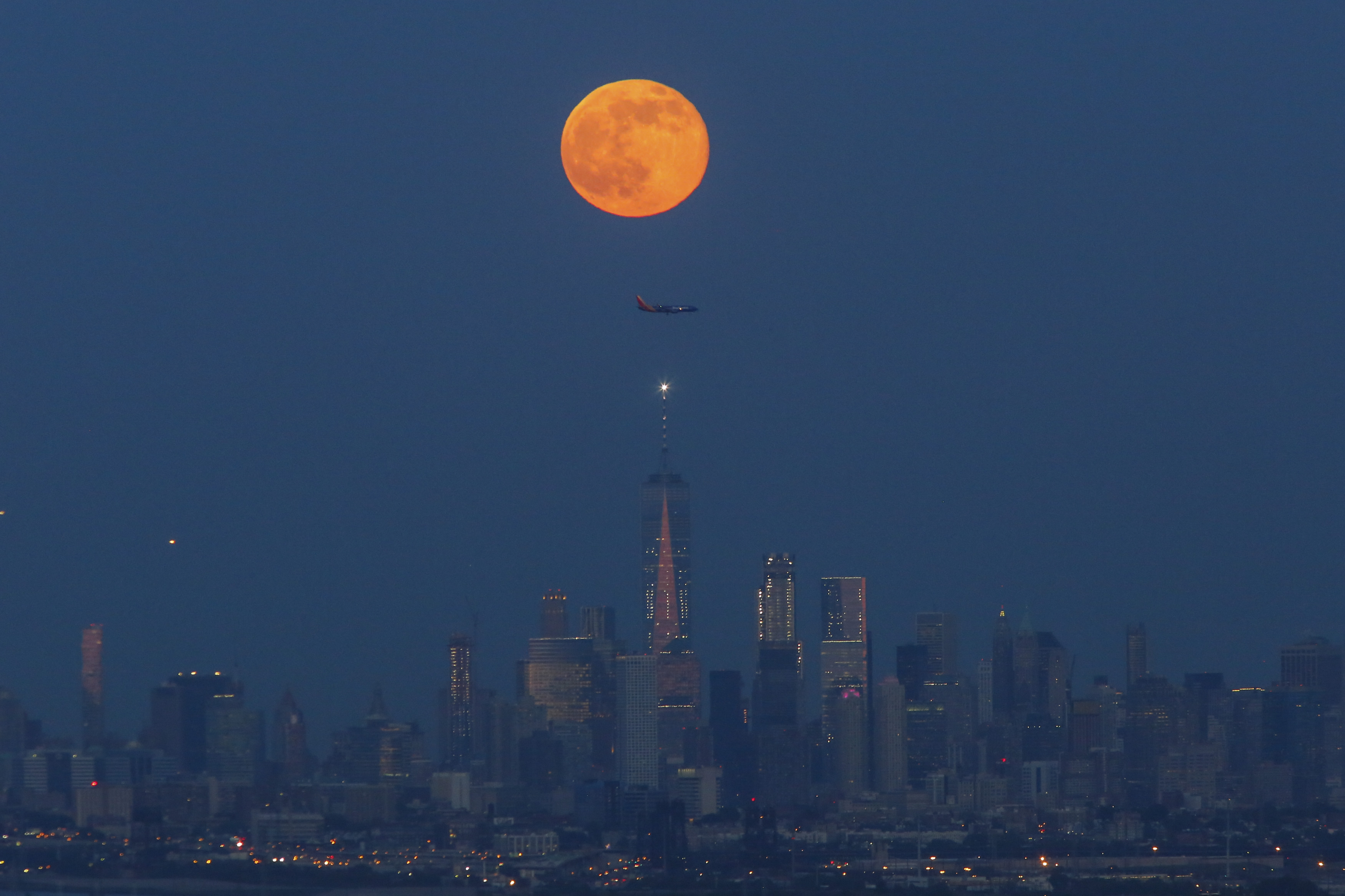 The Strawberry Moon rises over lower Manhattan and One World Trade Center on June 06, 2017 in Montclair, New Jersey. (Photo by Kena Betancur/VIEWpress/Corbis via Getty Images) (VIEW press—Corbis via Getty Images)