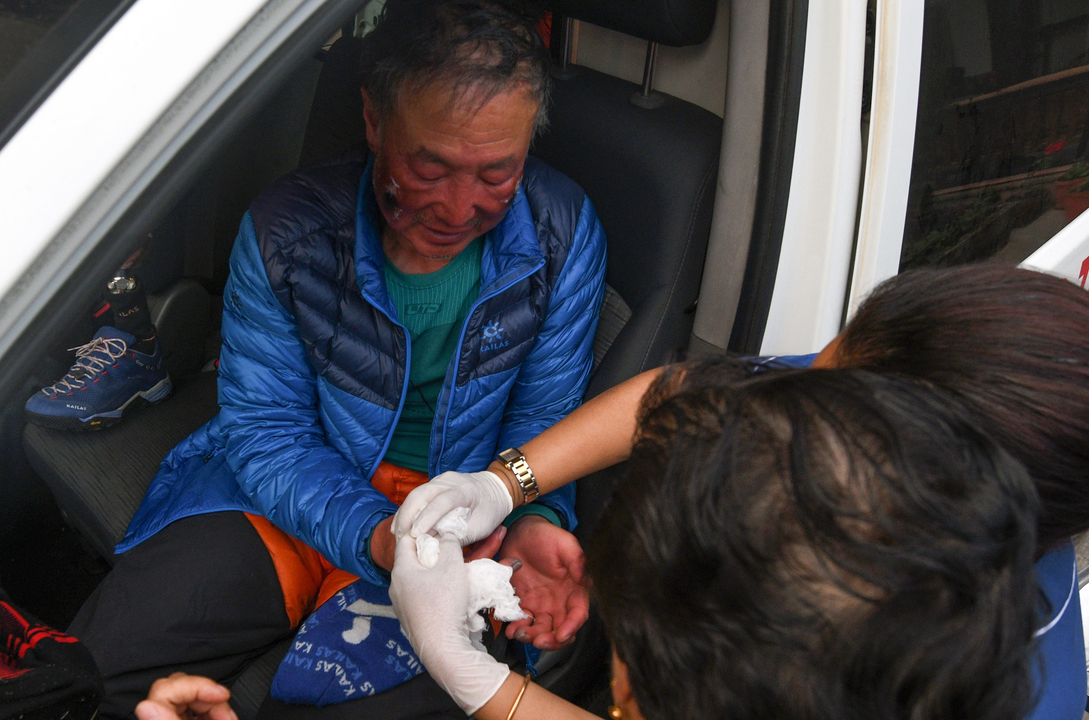 In this picture taken on May 16, 2018, Chinese double amputee climber Xia Boyu receives medical attention after returning from a successful summit of Mount Everest in Kathmandu. (Prakash Mathema—AFP/Getty Images)