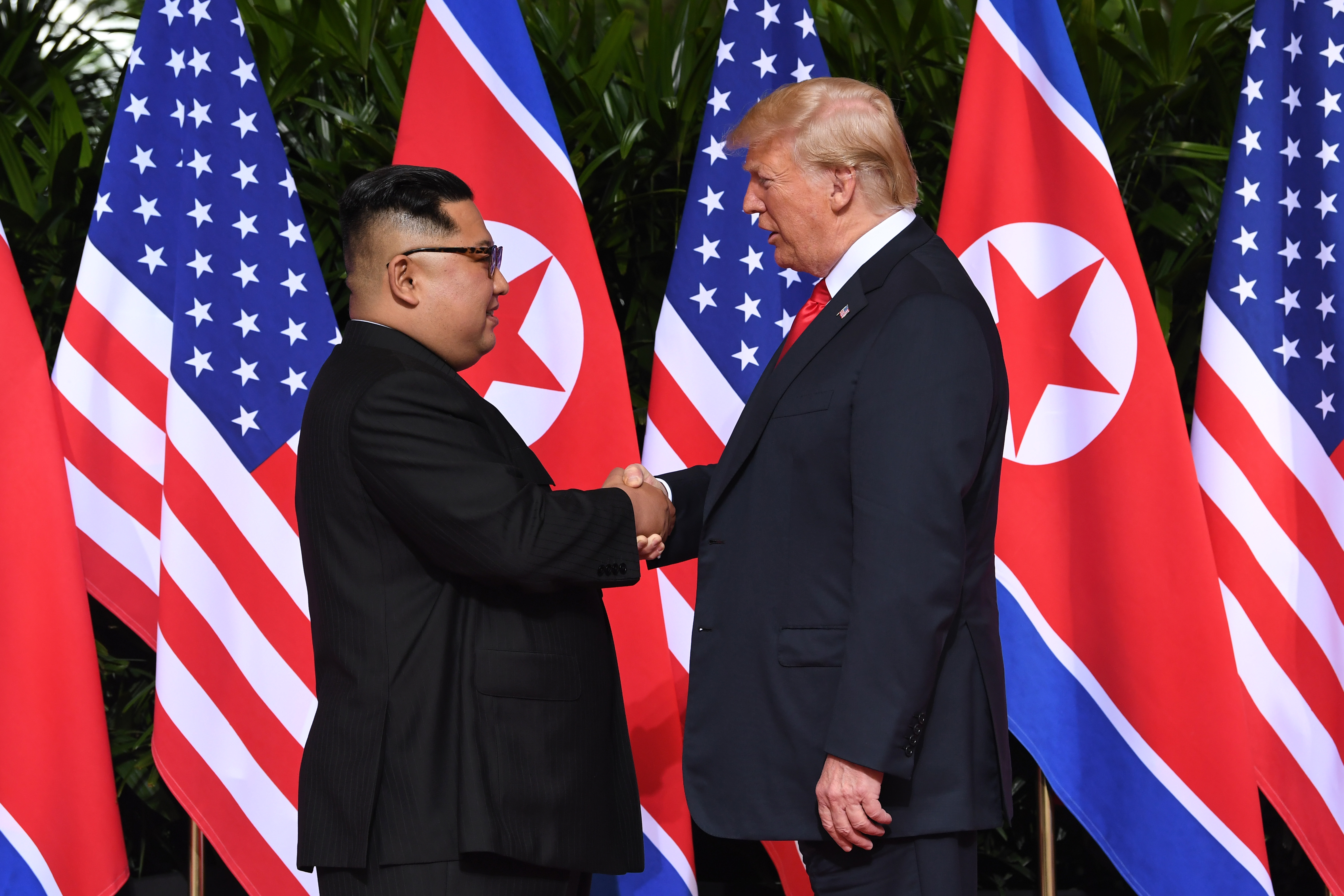 North Korea's leader Kim Jong Un shakes hands with President Donald Trump at the start of their historic U.S.-North Korea summit, at the Capella Hotel on Sentosa island in Singapore on June 12, 2018. (Saul Loeb—AFP/Getty Images)