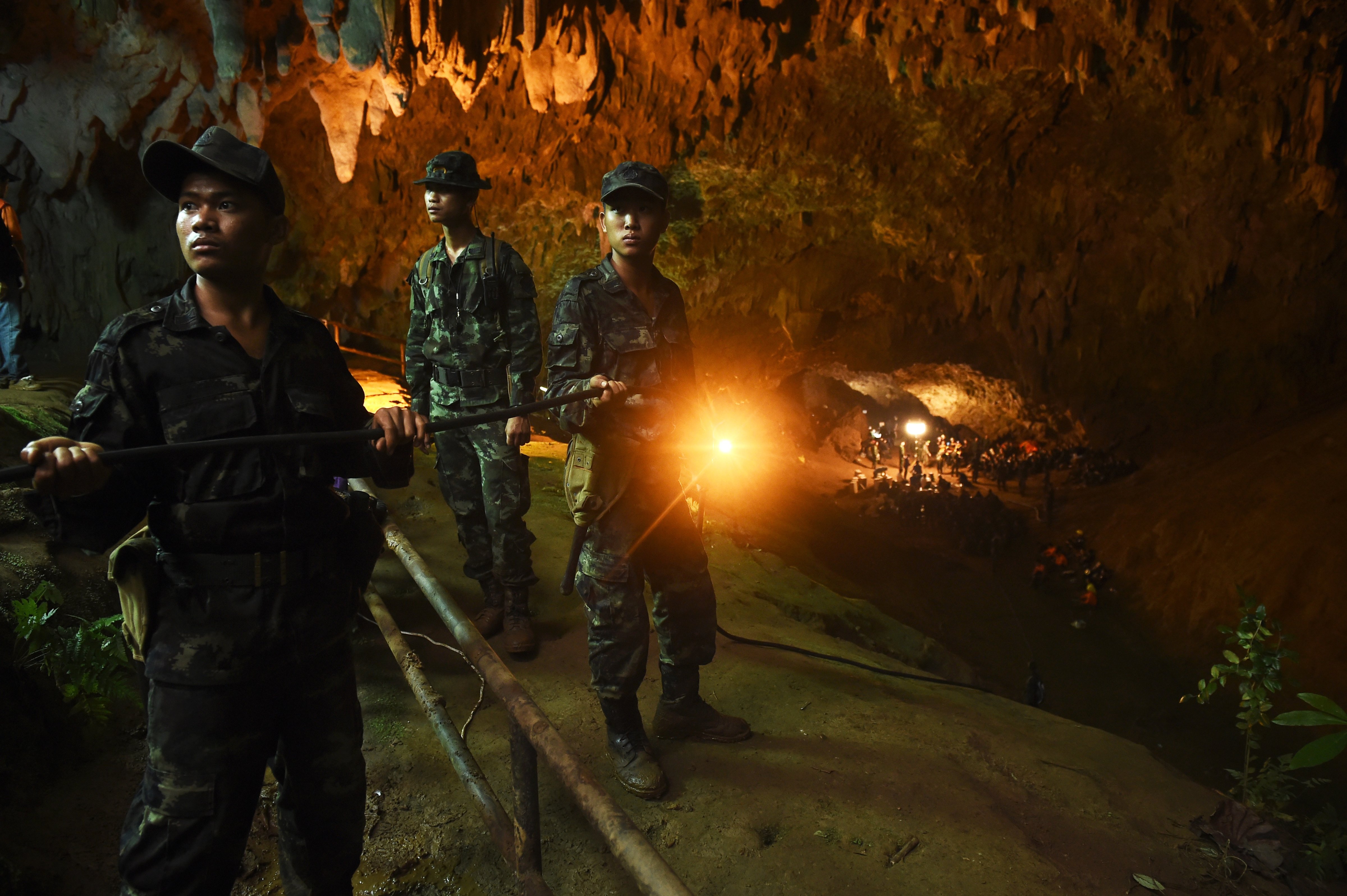 Thai soldiers relay electric cable deep into the Tham Luang cave at the Khun Nam Nang Non Forest Park in Chiang Rai on June 26, 2018. (Lillian Suwanrumpha—AFP/Getty Images)