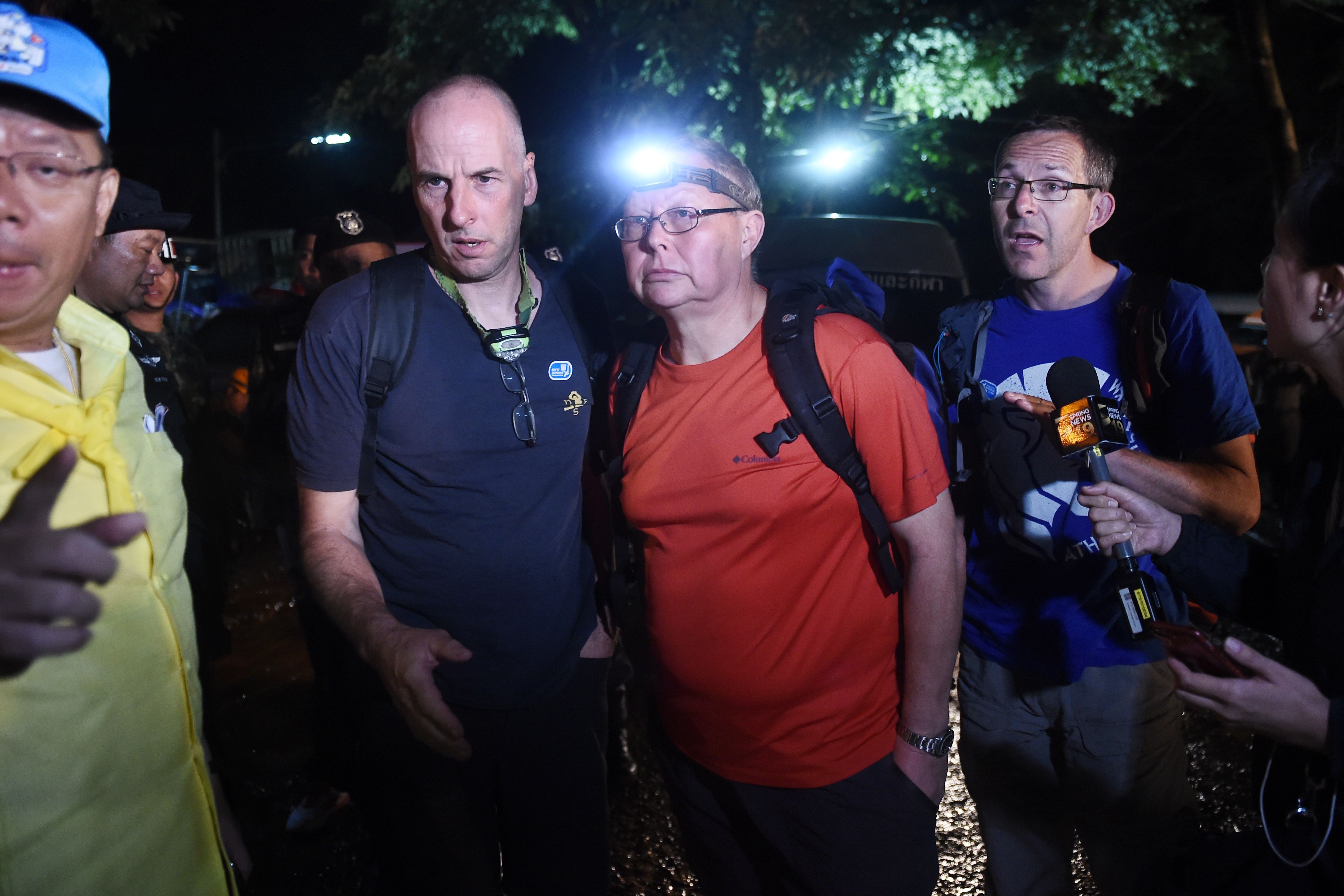 Three British cave-divers, Richard William Stanton (2nd-L), Robert Charles Harper (3rd-L) and John Volanthen (R) near the Tham Luang cave in Chiang Rai on June 27, 2018. (Lillian Suwanrumpha—AFP/Getty Images)