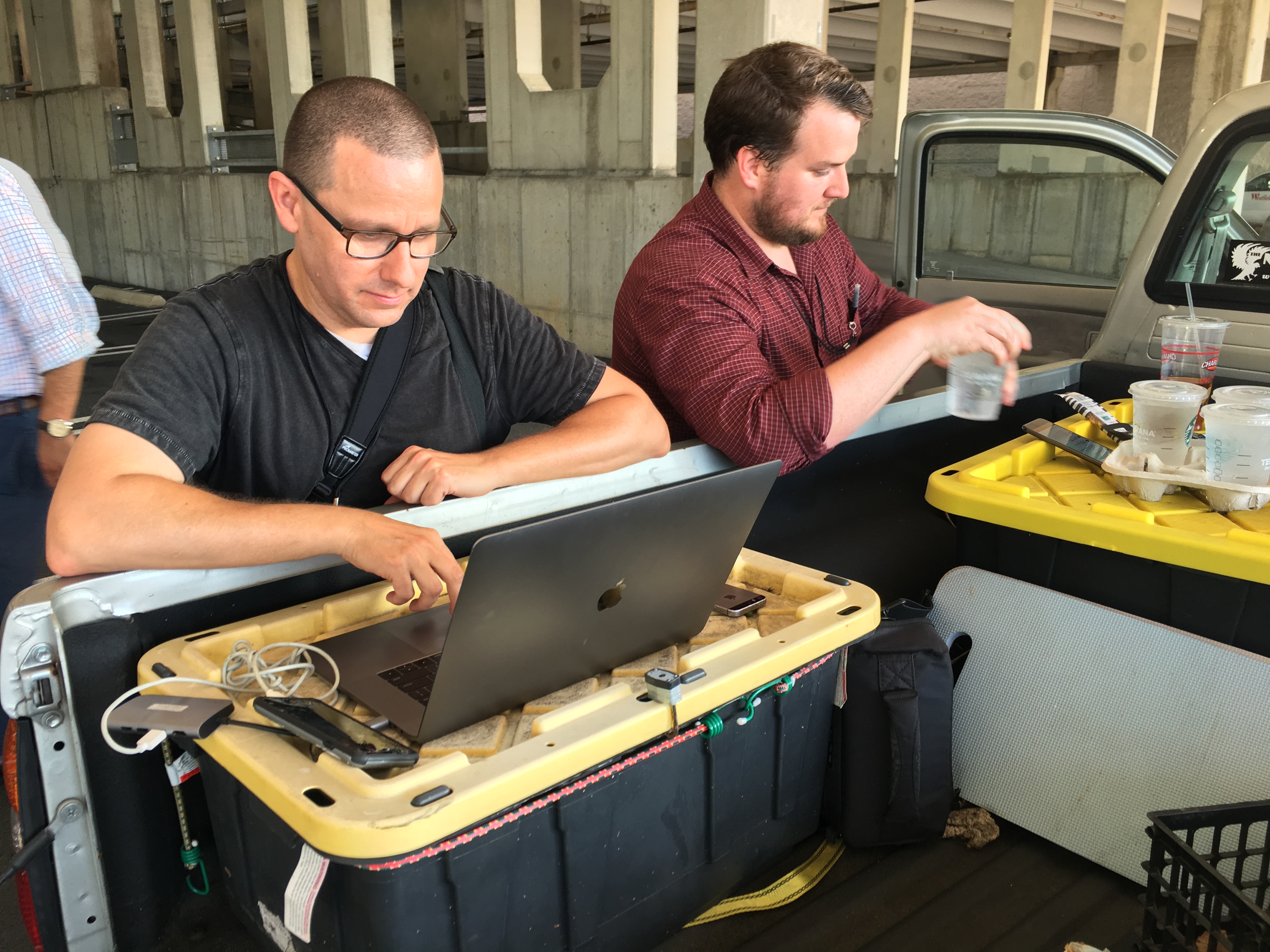 Capital Gazette reporter Chase Cook (R) and photographer Joshua McKerrow (L) work on the next days newspaper while awaiting news from their colleagues in Annapolis, Maryland, June 28, 2018. (Ivan Couronne—AFP/Getty Images)
