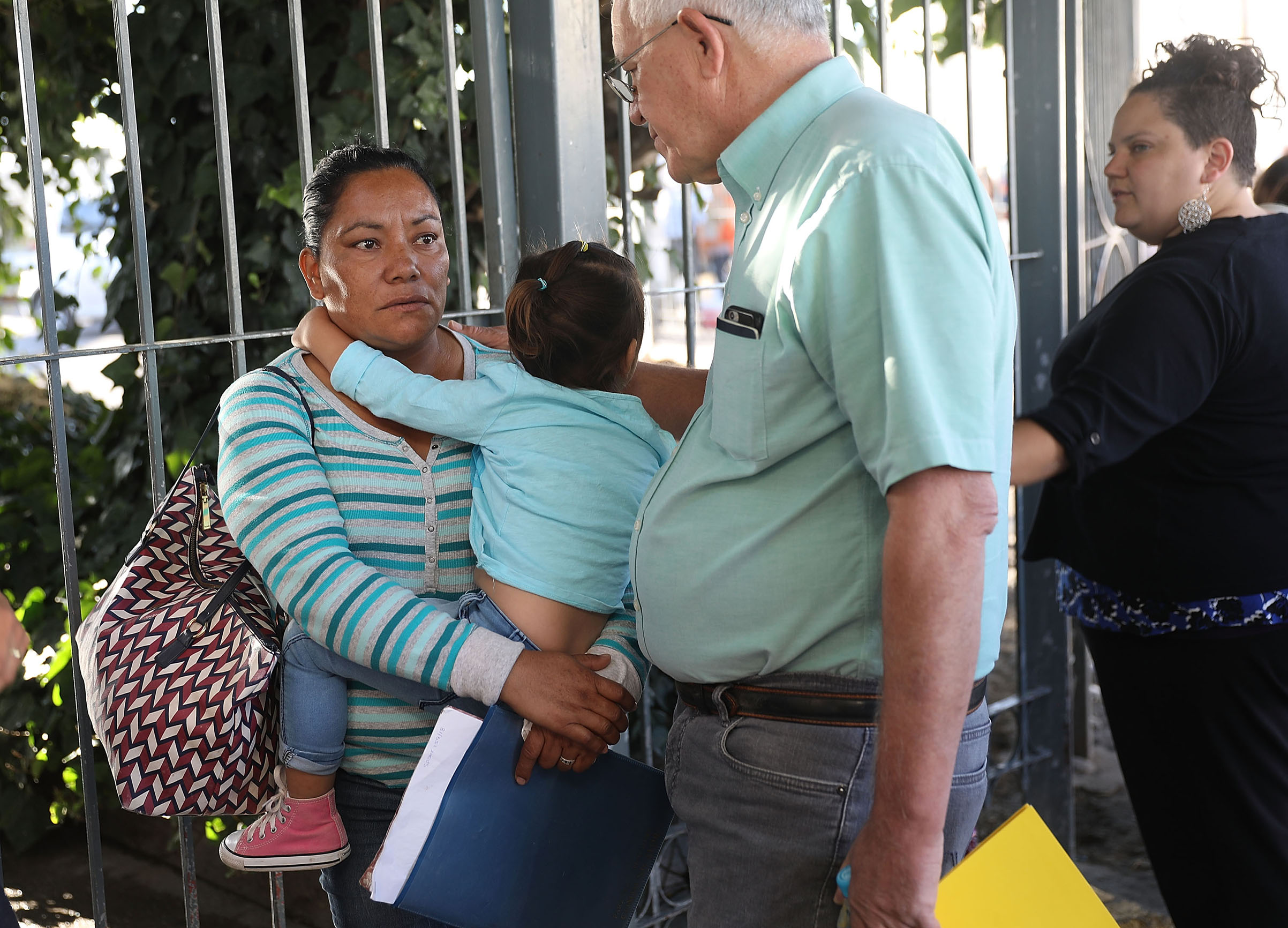 Ruben Garcia, director of the Annunciation House, speaks with Karla (who didn't want her last name used) before he helps her cross the Paso Del Norte Port of Entry to ask for asylum for herself and her grandchild in the United States on June 20, 2018 in Ciudad Juarez, Mexico. The Trump Administration's controversial zero tolerance immigration policy has led to an increase in the number of migrant children who have been separated from their families at the southern U.S. border. U.S. Attorney General Jeff Sessions has added that domestic and gang violence in immigrants' country of origin would no longer qualify them for political asylum status. (Joe Raedle—Getty Images)