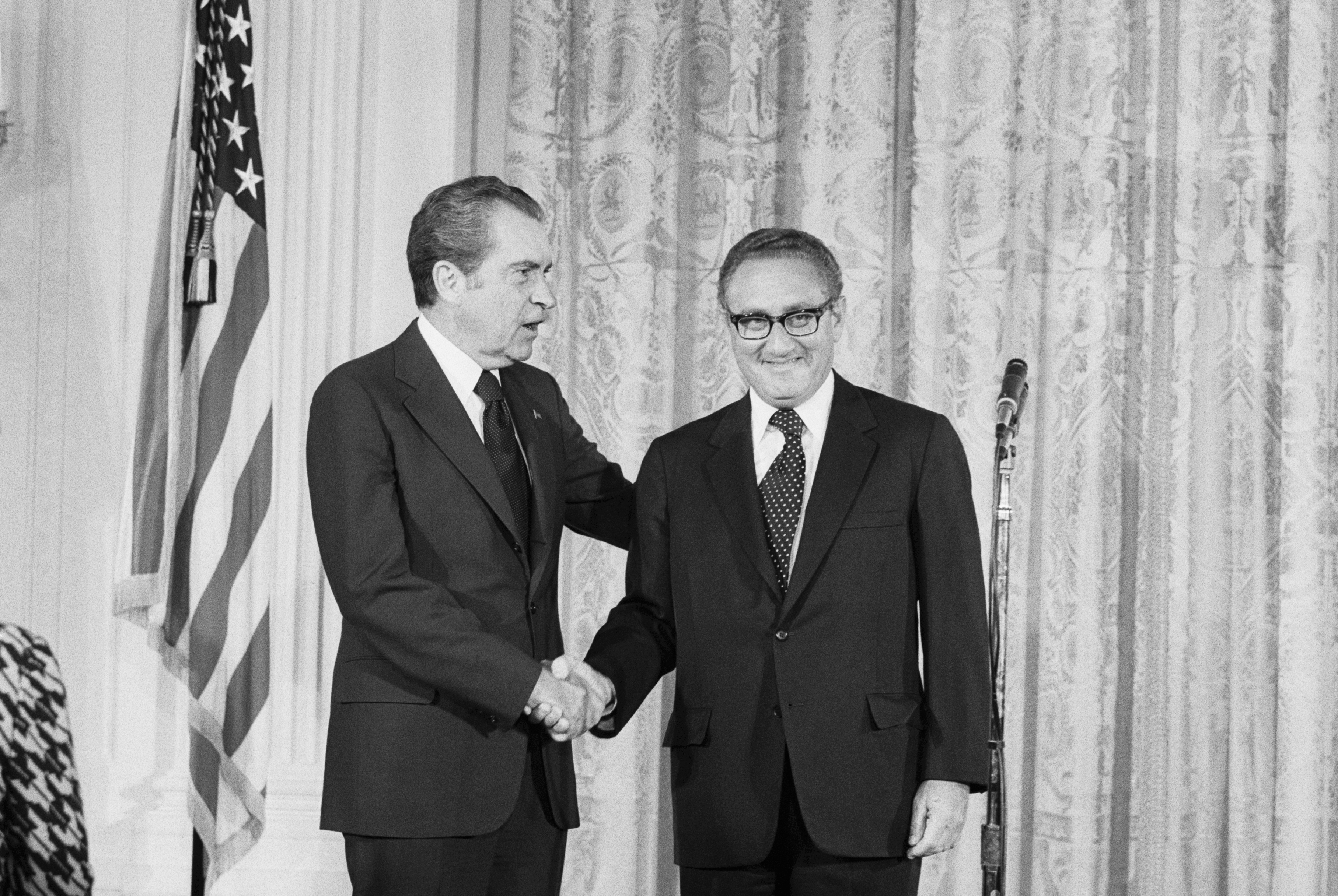 Pres. Nixon congratulates Henry Kissinger after he was sworn in as Secretary of State in a ceremony in the East Room of the White House. (Bettmann—Bettmann Archive)