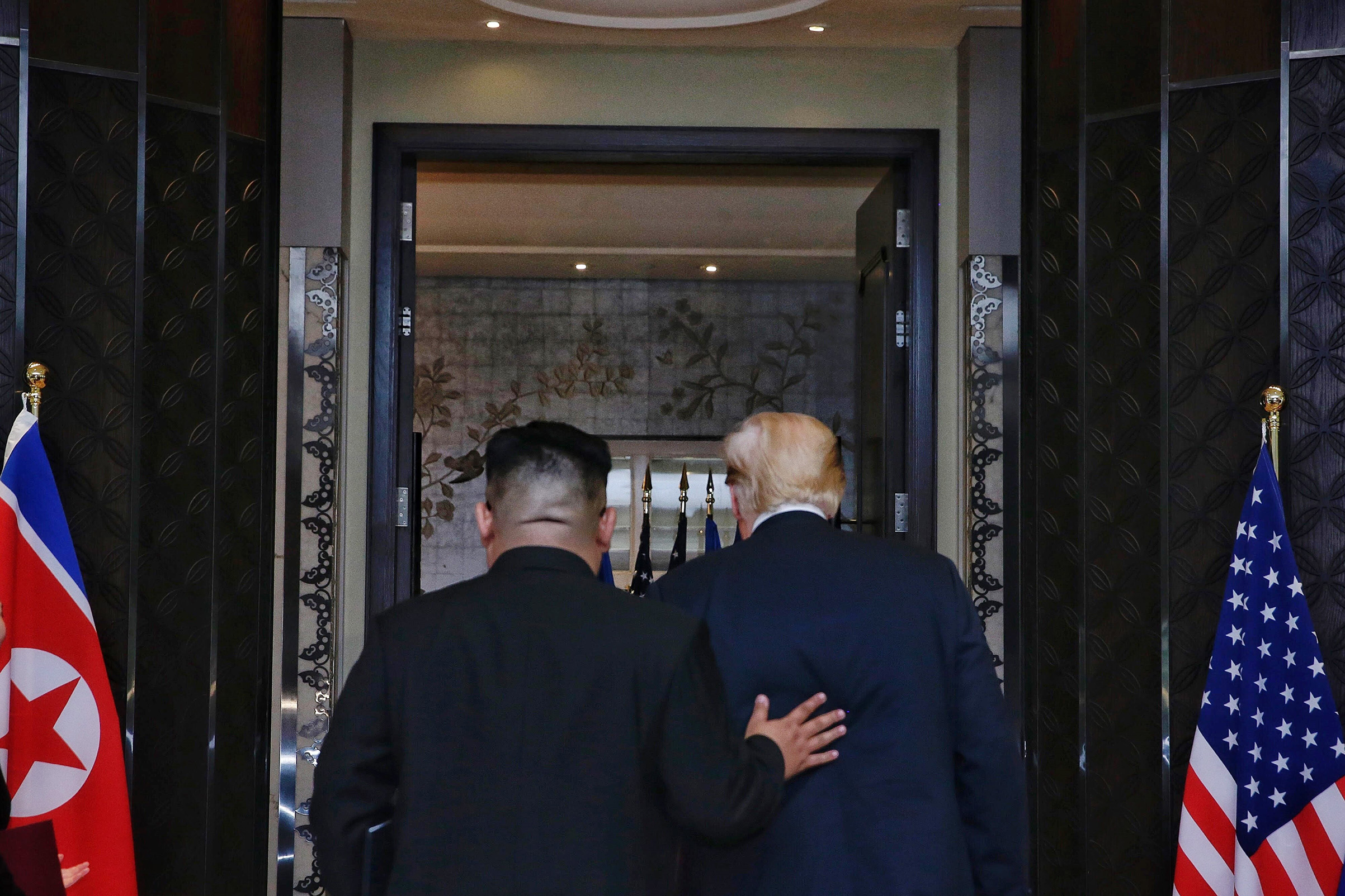 Kim and Trump depart the signing ceremony at the end of their meeting in Singapore on June 12 (Kevin Lim—The Straits Times/Anadolu Agency/Getty Images)