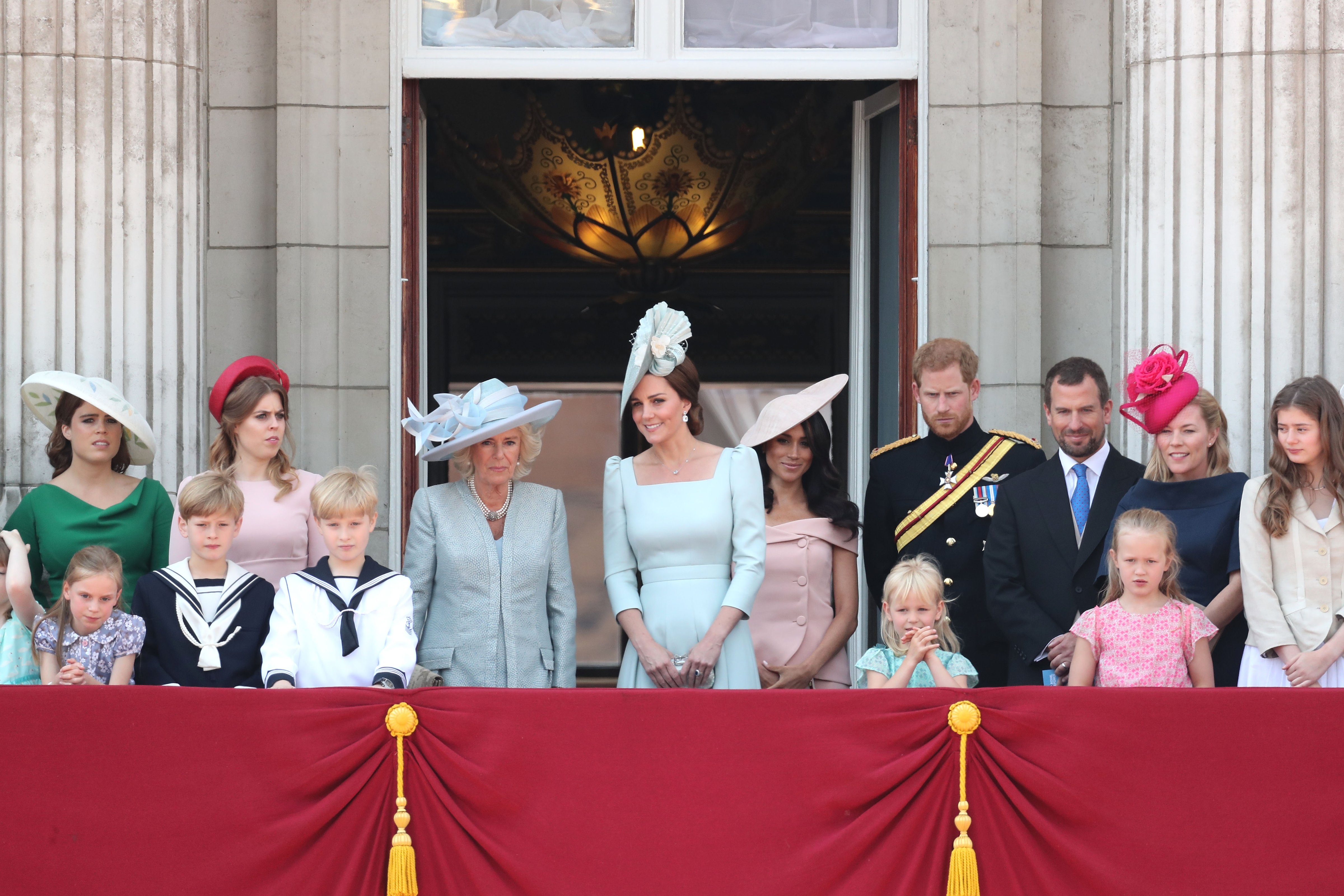 (From left to right) Princess Eugenie, Princess Beatrice, Camilla, Duchess Of Cornwall, Kate Middleton, Duchess of Cambridge, Meghan Markle, Duchess of Sussex, Prince Harry, Duke of Sussex. (Front row, left to right) Peter Phillips, Autumn Phillips, Isla Phillips and Savannah Phillips on the balcony of Buckingham Palace during Trooping The Colour on June 9, 2018 in London, England (Chris Jackson—Getty Images)