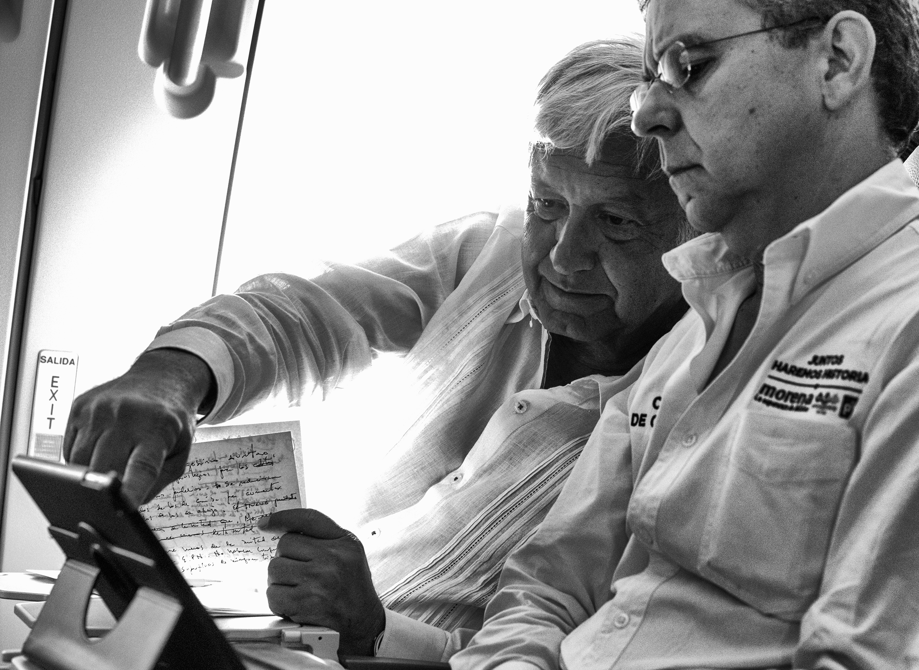 López Obrador works on a final campaign speech, alongside his Press Secretary César Yáñez, on a commercial flight to Cancún ahead of the July 1 elections. (Christopher Morris—VII for TIME)