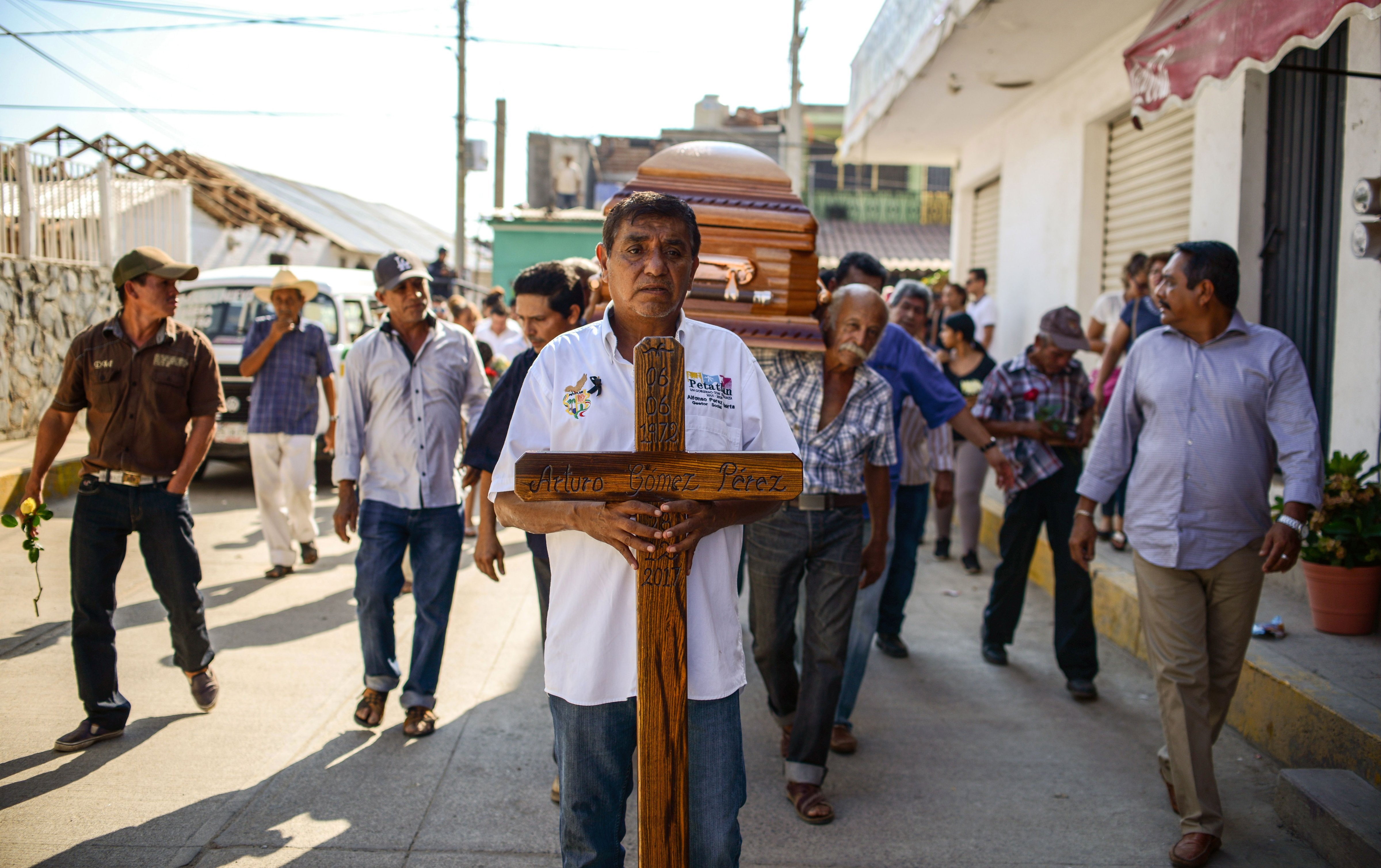 Relatives and friends of the mayor of the Mexican community of Petatlan, Arturo Gomez, carry his coffin during his funeral in Petatlan, Guerrero State, on December 29, 2017 a day after he was shot dead while dining at a restaurant.
                      An armed group killed mayor Gomez in the convulsed state of Guerrero in southern Mexico, according to the security spokesman for the Guerrero government Roberto Alvarez. (Francisco Robles 
                       – AFP/Getty Images)