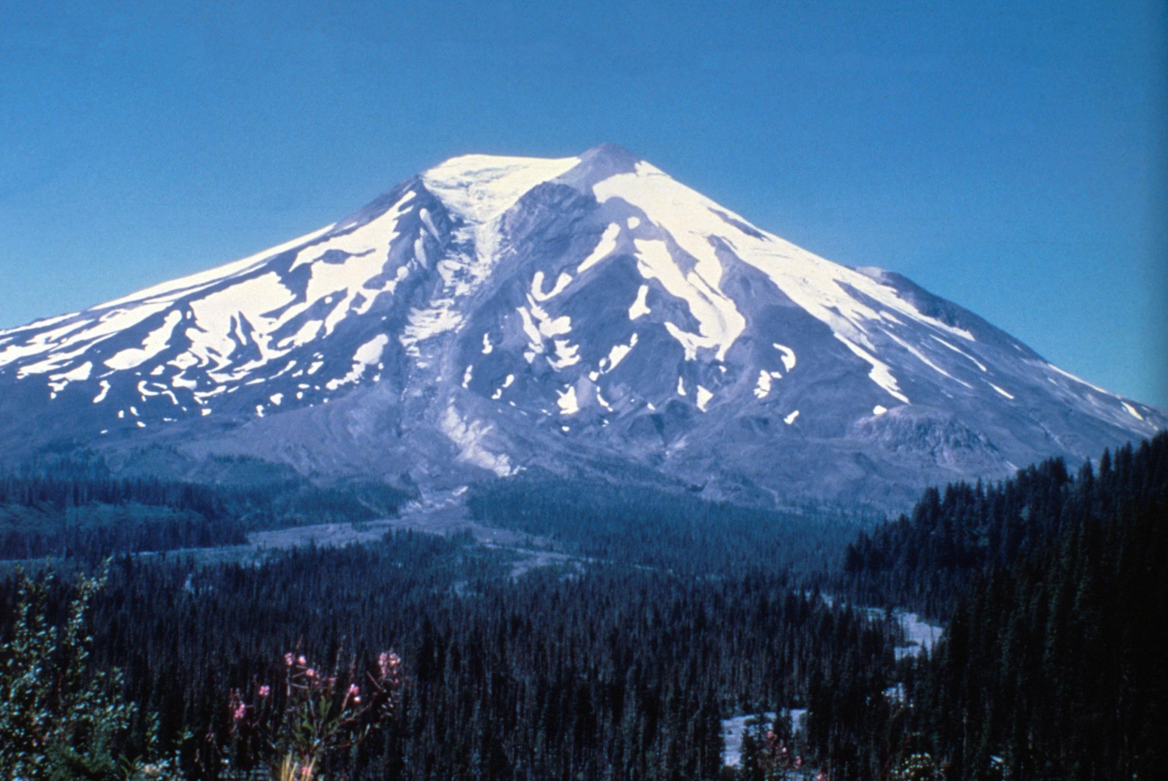 Southeast side of Mount St. Helens, showing Shoestring Glacier. This pre-1980 view of Mount St. Helens shows the volcano's southeast flank and the headwaters of the Muddy River before the May 18th, 1980 eruption. The broad forested area in the foreground i