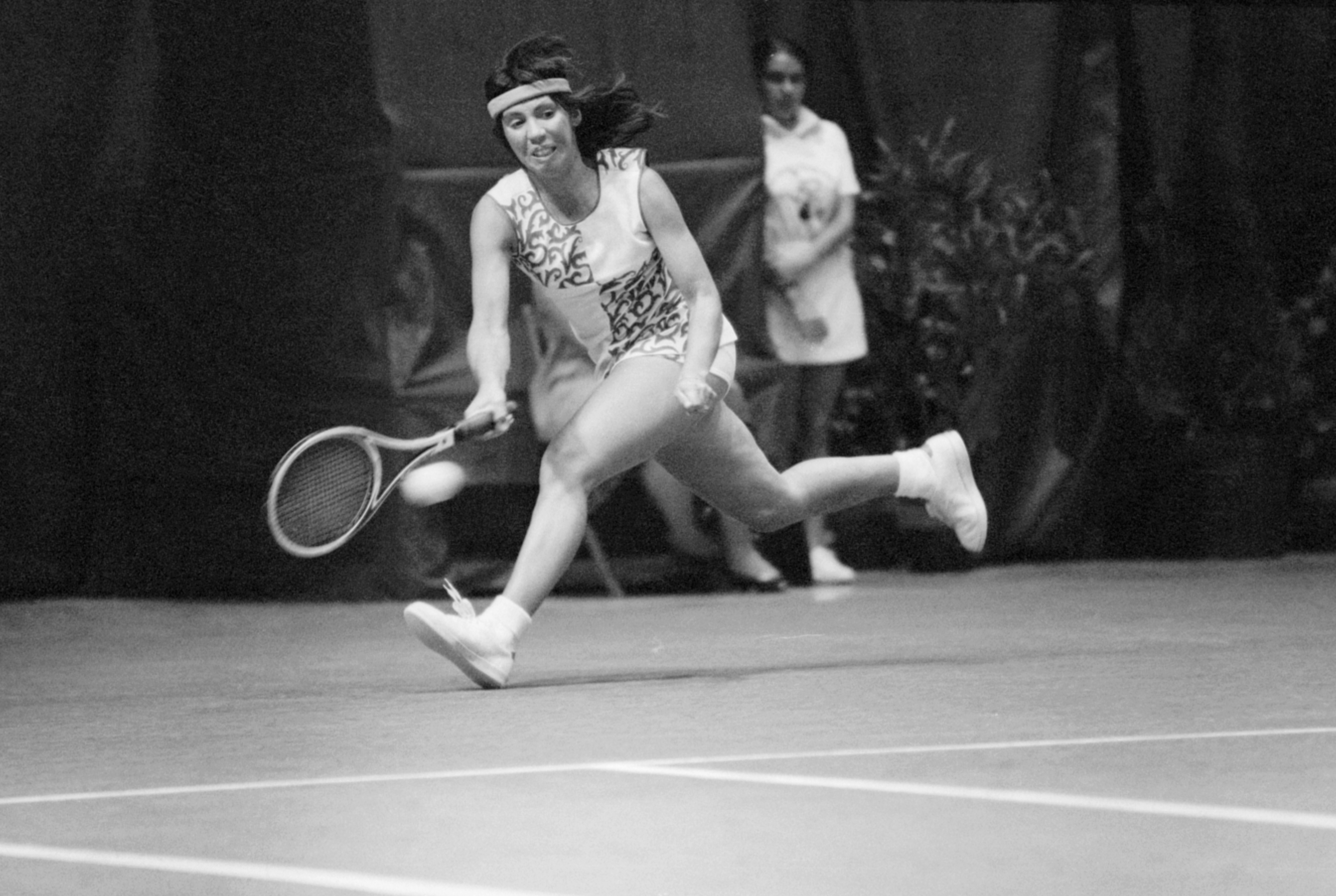 Tennis pro Rosie Casals races to reach a serve by Kerry Nelville in their match in the Virginia Slims Tennis Tournament here 4/26. Casals won in two sets, 6-2, 6-4. (Bettmann—Bettmann Archive)