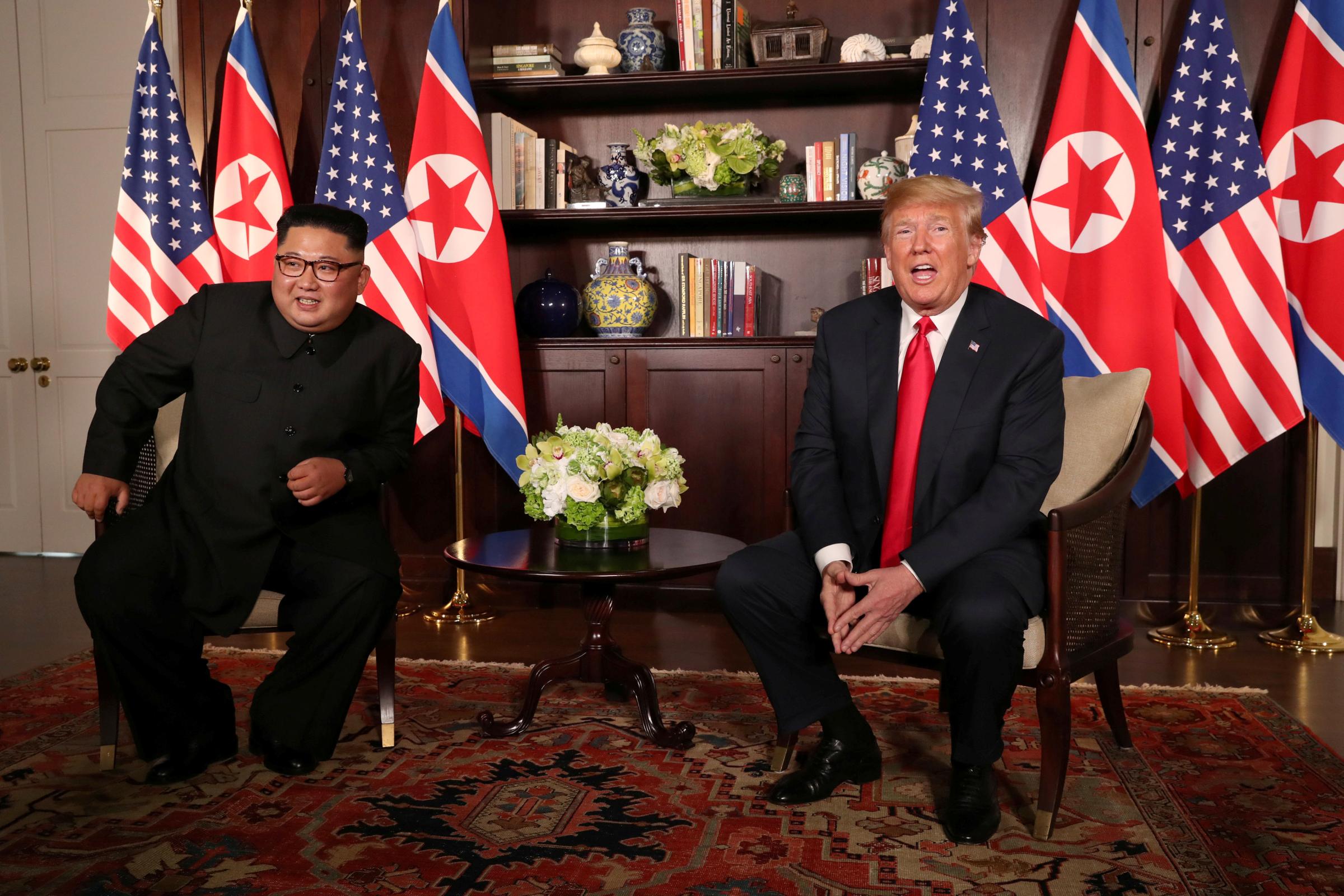 U.S. President Donald Trump sits next to North Korea's leader Kim Jong Un at the Capella Hotel in Singapore