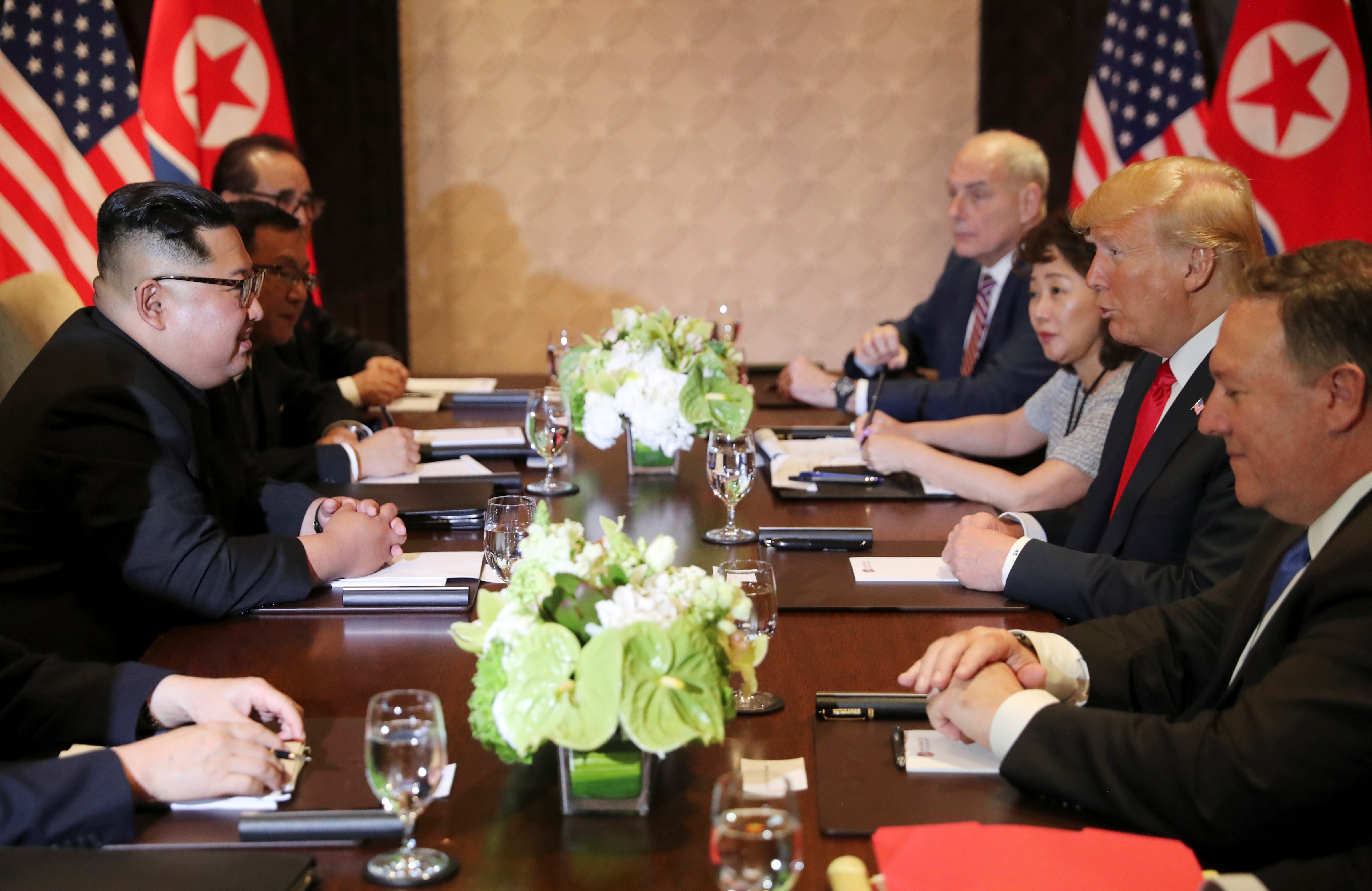 President Donald Trump, with Yun Hyang Lee at his side, speaks to North Korea's leader Kim Jong Un before their expanded bilateral meeting at the Capella Hotel on Sentosa island in Singapore June 12, 2018. (Jonathan Ernst—Reuters.)