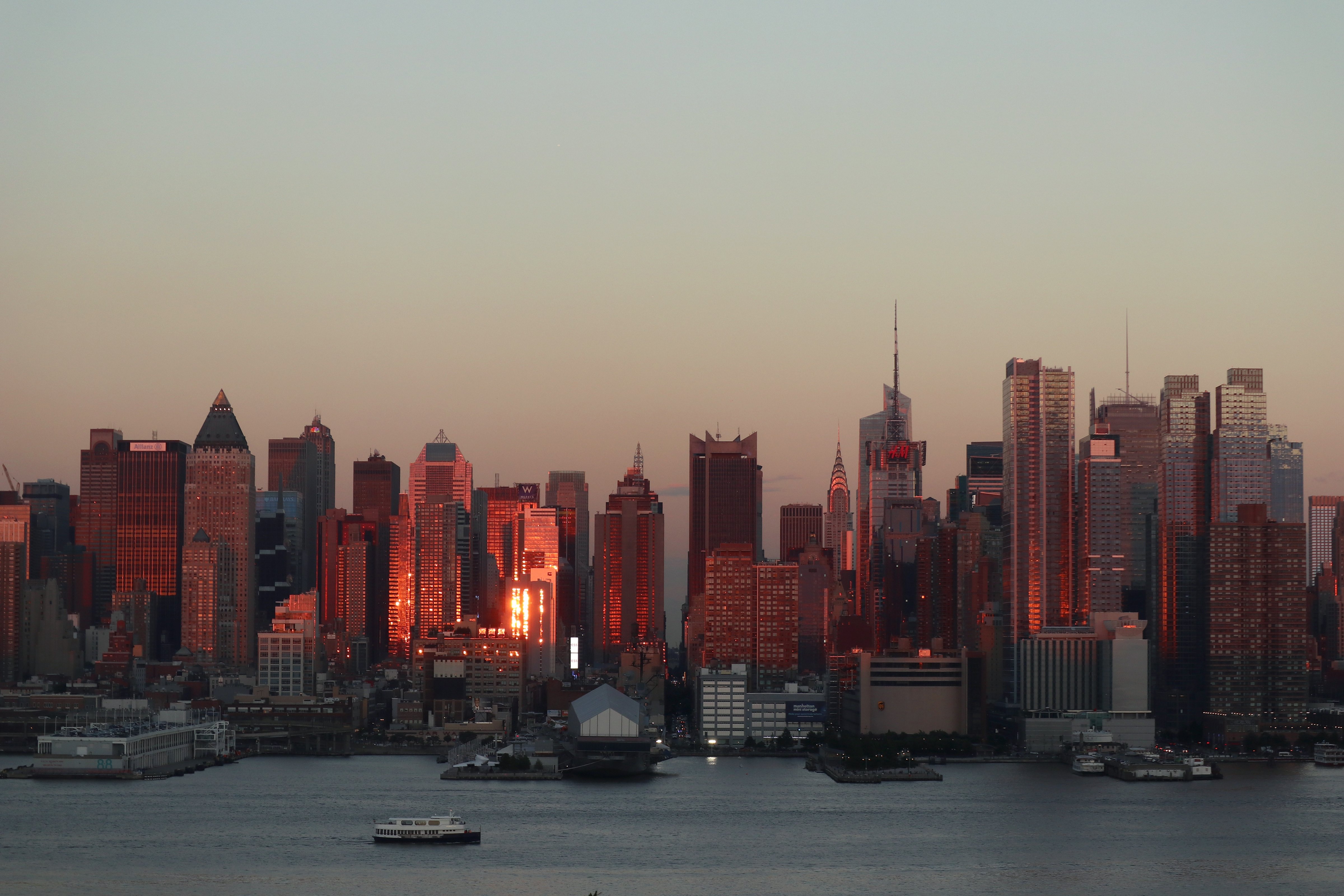 The sun sets on midtown Manhattan and the Chrysler Building on the summer solstice in New York City on June 21, 2017 as seen from Weehawken, NJ. (Gary Hershorn—Getty Images)