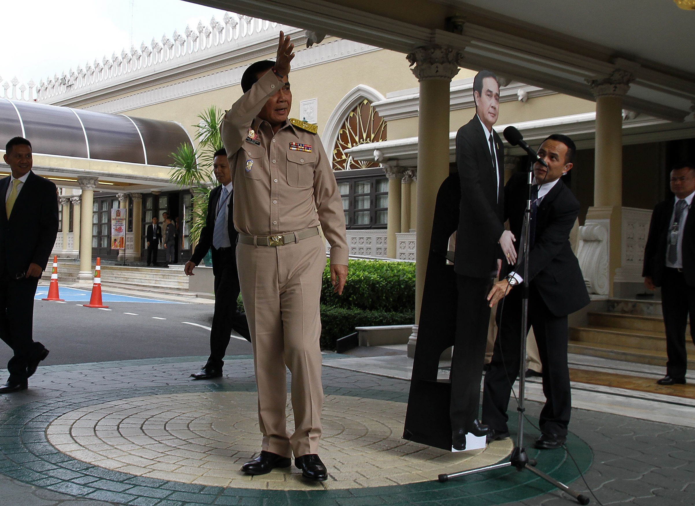 The Thai leader leaves a Jan. 8 press conference, telling reporters to direct questions to a cardboard cutout (Daily News/AFP/Getty Images)