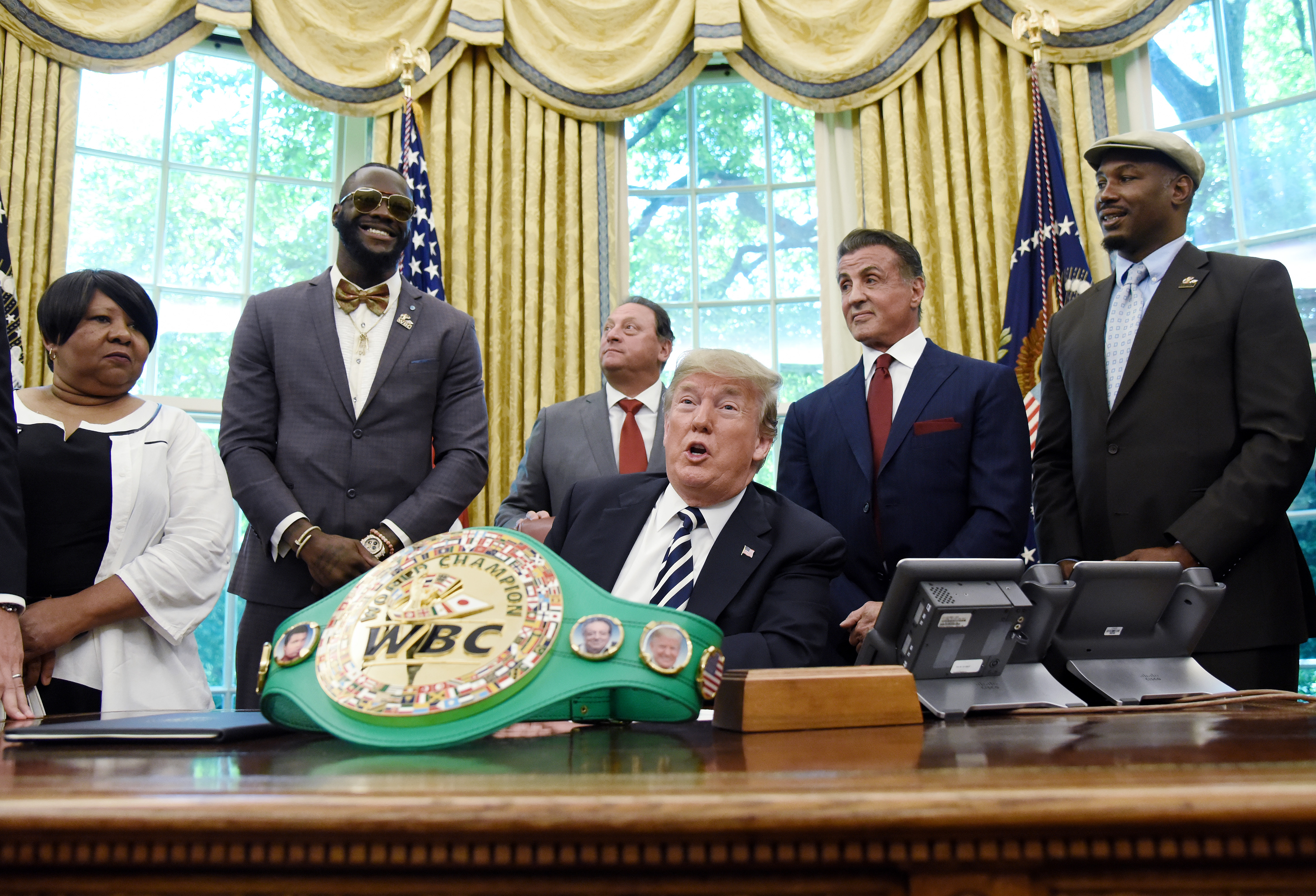 U.S. President Donald Trump speaks after signing an executive order granting a posthumous pardon for Jack Johnson, the first black heavyweight boxing champion, as boxing champion Lenox Lewis, from left, and actor Sylvester Stallone attend in the Oval Office of the White House in Washington, D.C., U.S., on Thursday, May 24, 2018. (Bloomberg&mdash;Bloomberg via Getty Images)