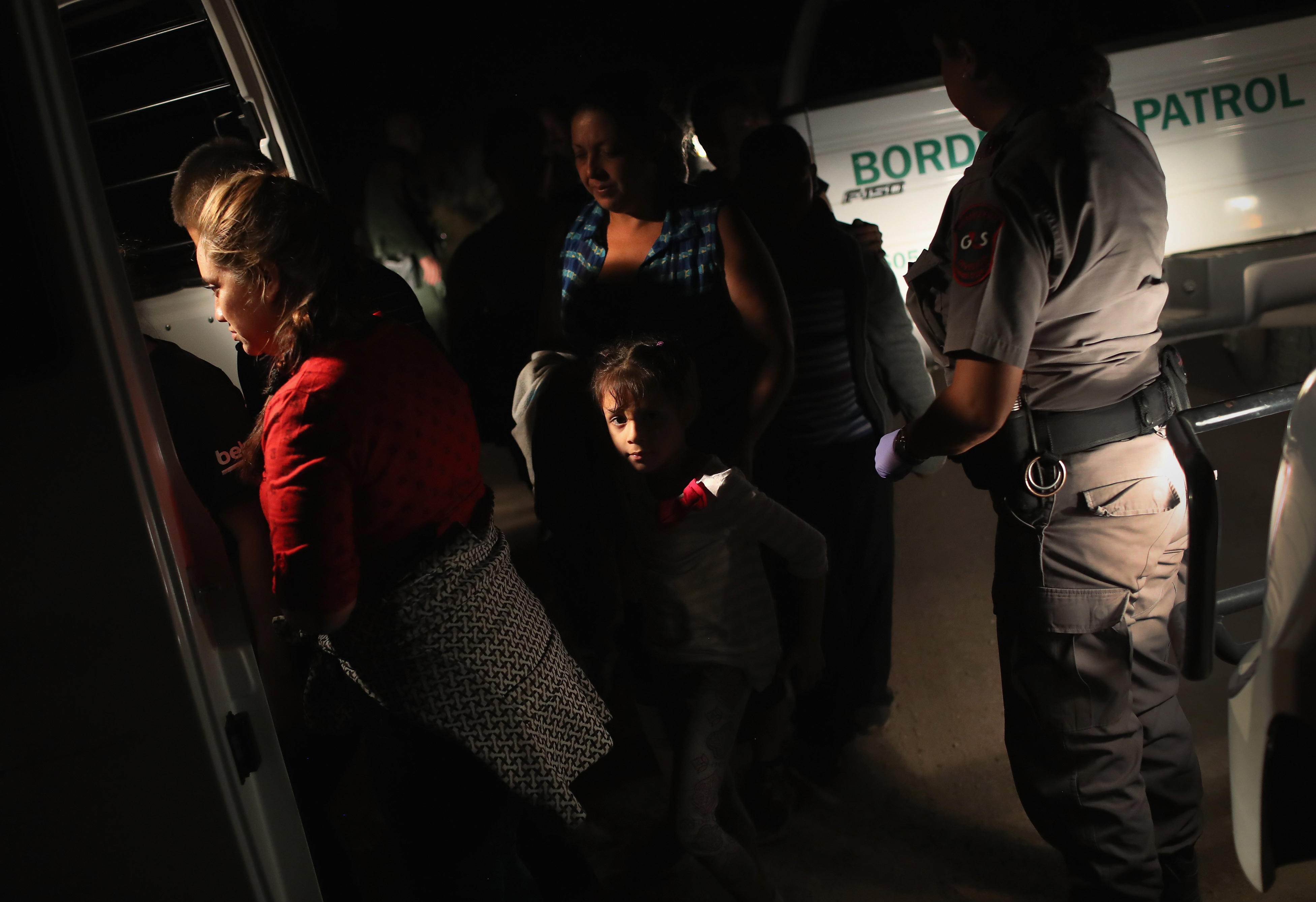 U.S. Border Patrol agents detain a group of Central American asylum seekers near the U.S.-Mexico border in McAllen, Texas on June 12, 2018. (John Moore—Getty Images)