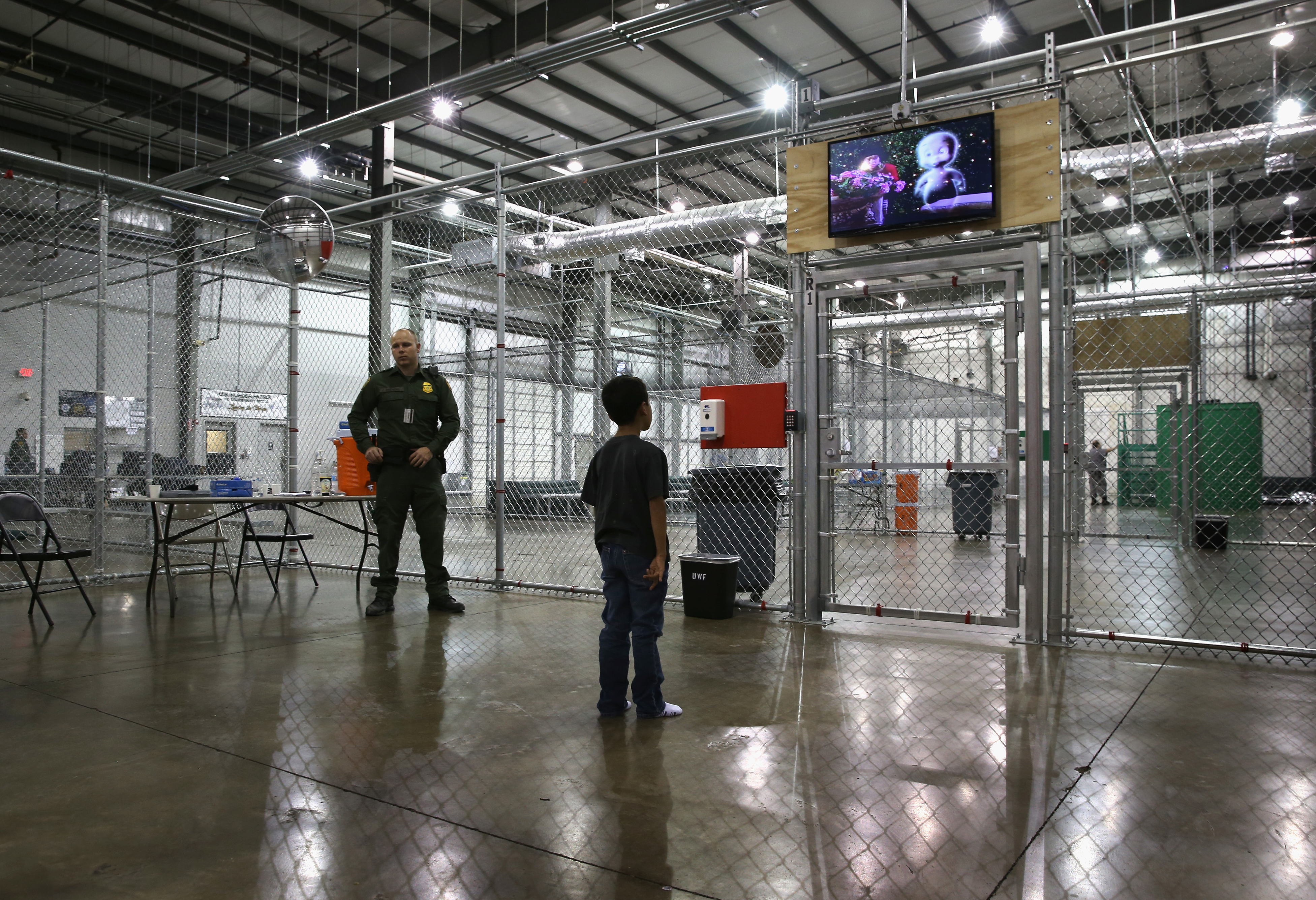 A boy from Honduras watches a movie at a detention facility run by the U.S. Border Patrol in McAllen, Tex. on Sept. 8, 2014. (John Moore—Getty Images)