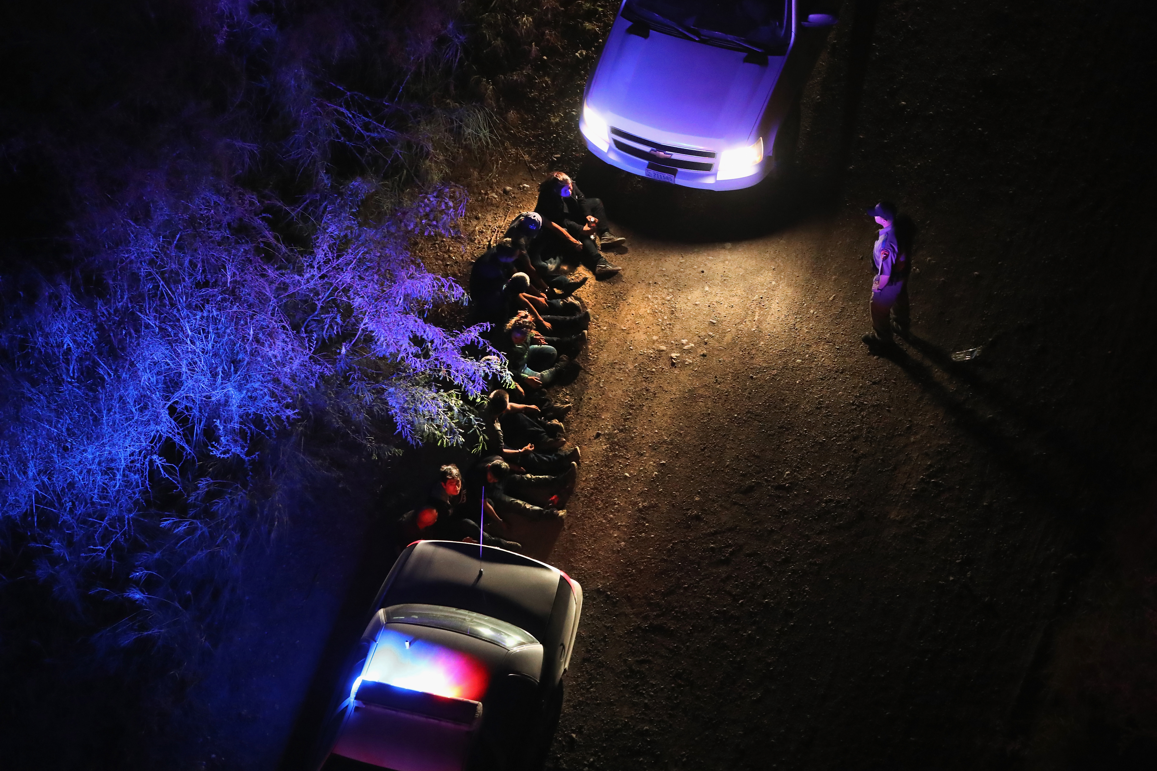 U.S. Border Patrol agents take undocumented immigrants into custody after capturing them after they crossed Rio Grande from Mexico into Texas near Sullivan City, Texas on Aug. 18, 2016. (John Moore—Getty Images)