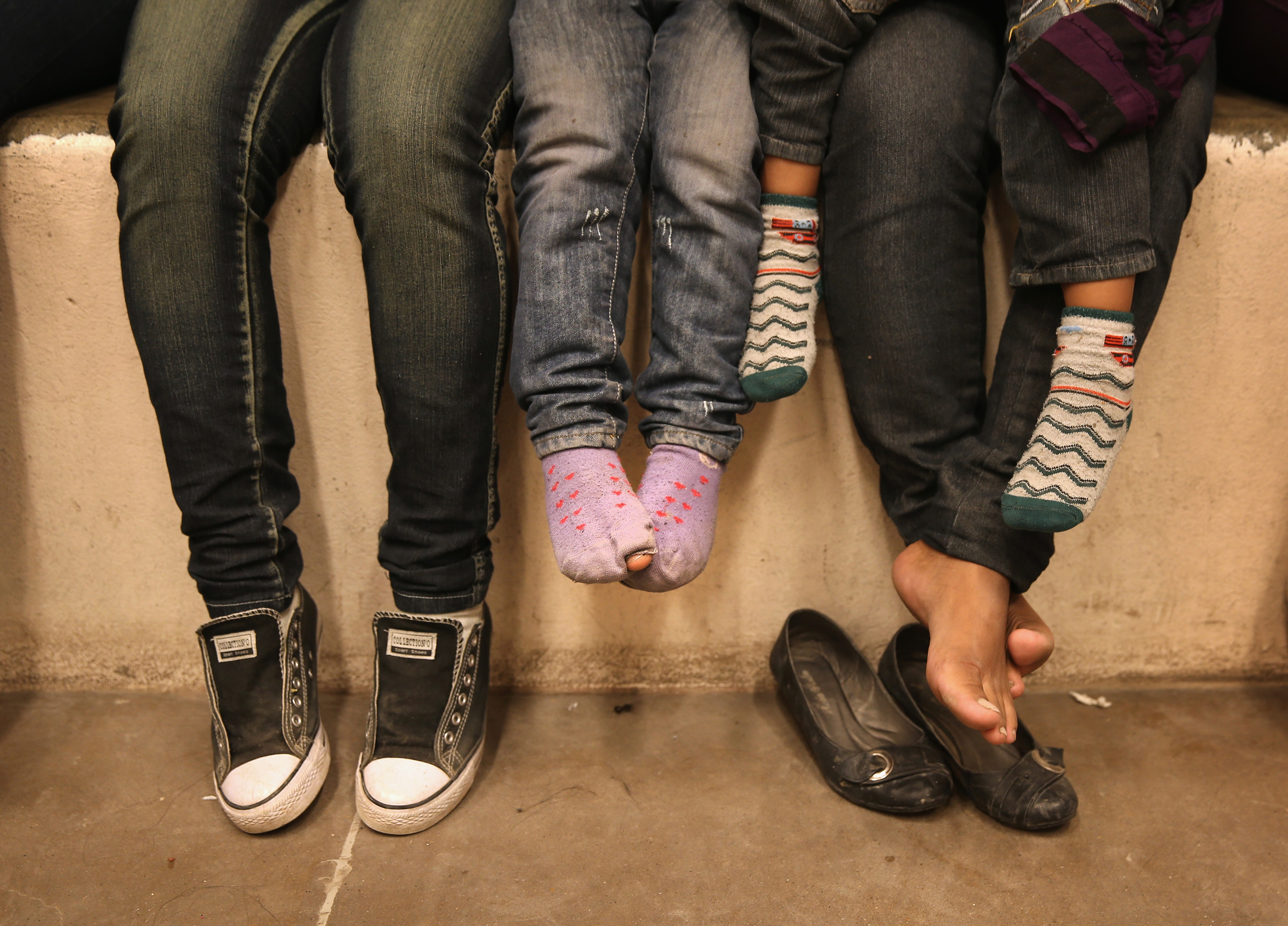 Women and children sit in a holding cell at a U.S. Border Patrol processing center after being detained by agents near the U.S.-Mexico border near McAllen, Texas on Sept. 8, 2014. (John Moore—Getty Images)