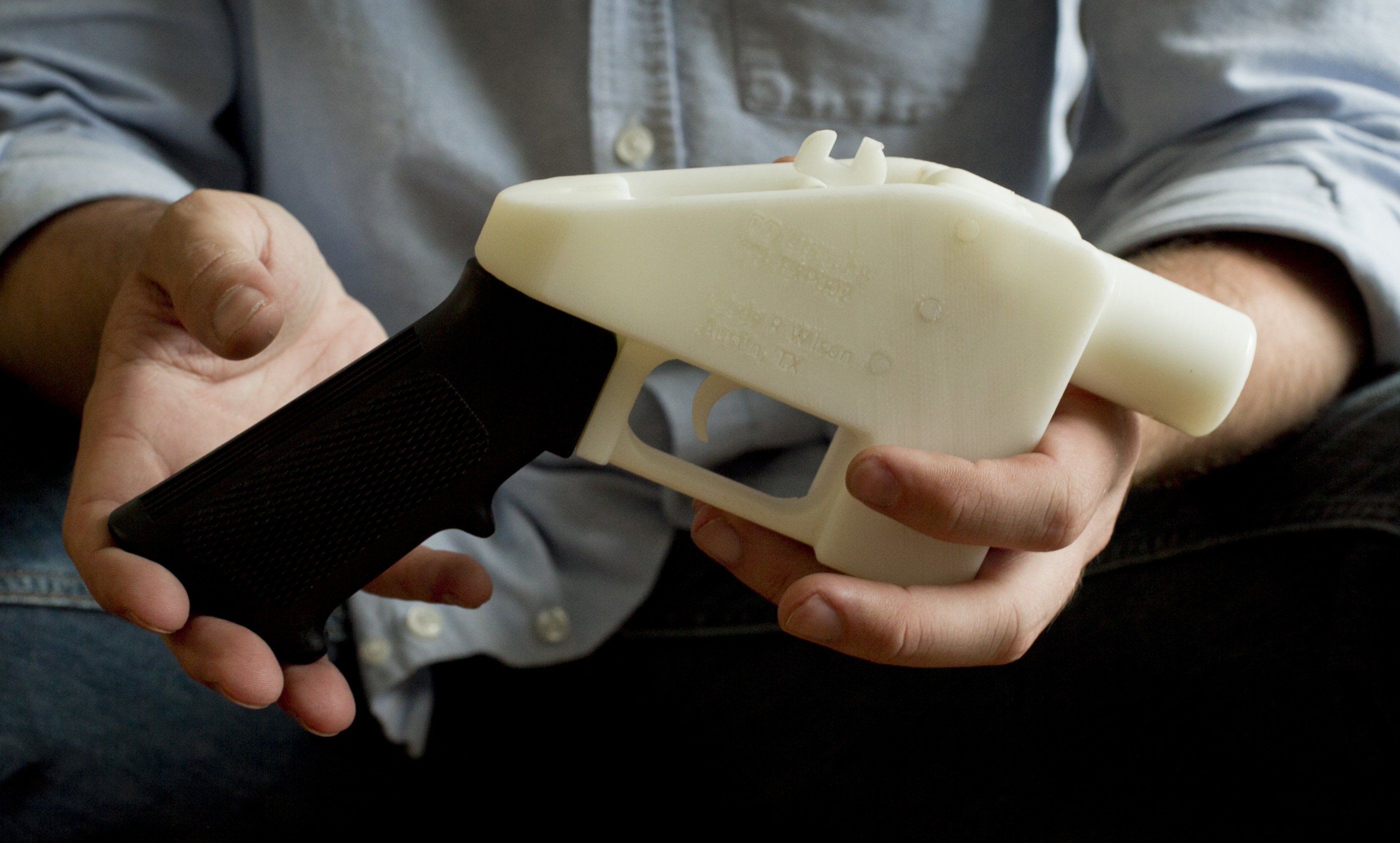 Cody Wilson holds what he calls a Liberator pistol that was completely made on a 3-D-printer at his home in Austin, Texas on May 10, 2013. (Jay Janner/Austin American-Statesman via AP, File)