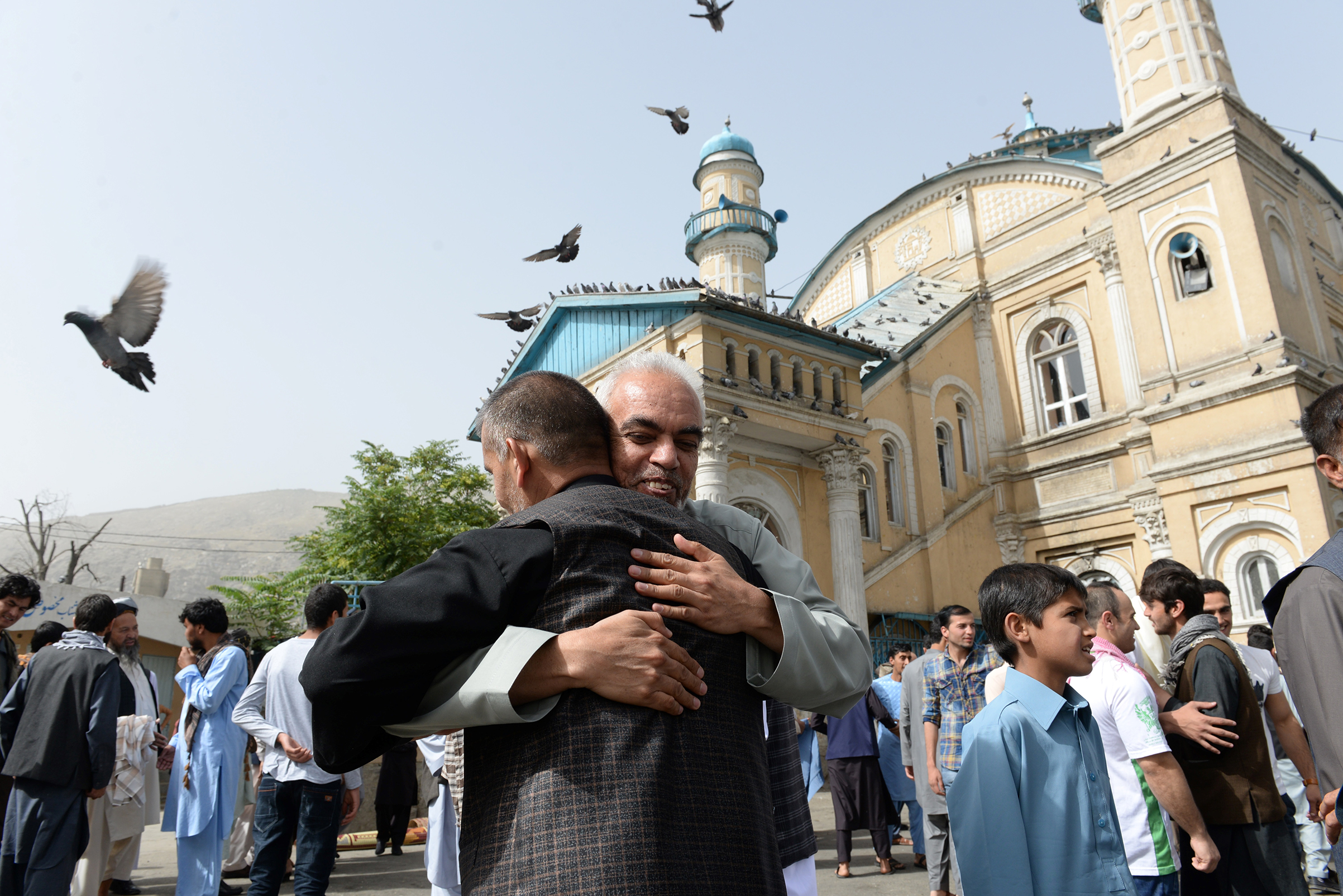 Afghan Muslims hug each other after offering prayers at the start of the Eid al-Fitr holiday which marks the end of Ramadan at the Shah-e Do Shamshira mosque in Kabul on June 15, 2018. (Noorullah Shirzada—AFP/Getty Images)