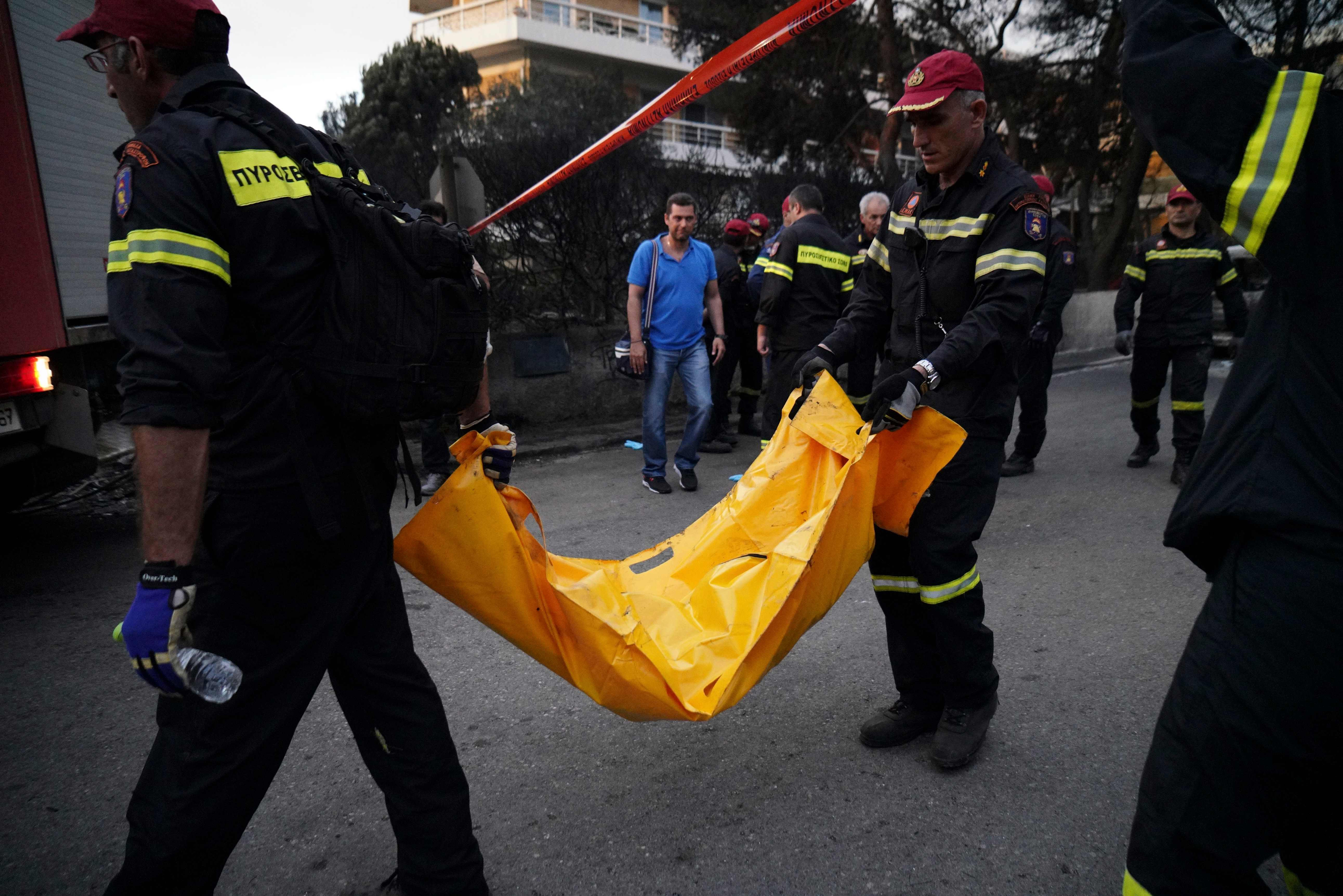Firefighters transport a body in Mati on July 24, 2018. (AFP/Getty Images)
