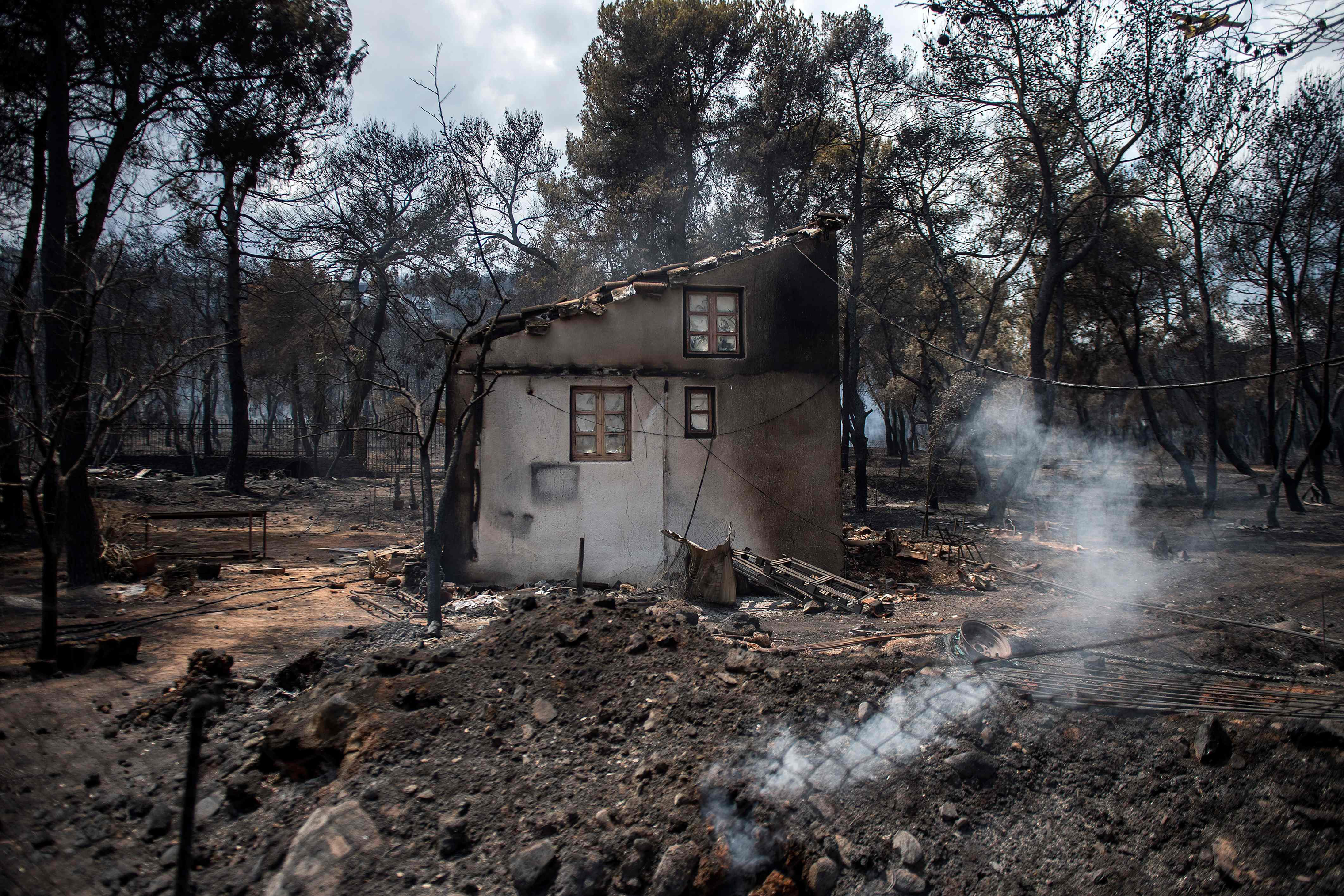 A photo shows a burned house following a wildfire at the village of Neos Voutzas, near Athens on July 24, 2018. (Angelos Tzortzinis—AFP/Getty Images)