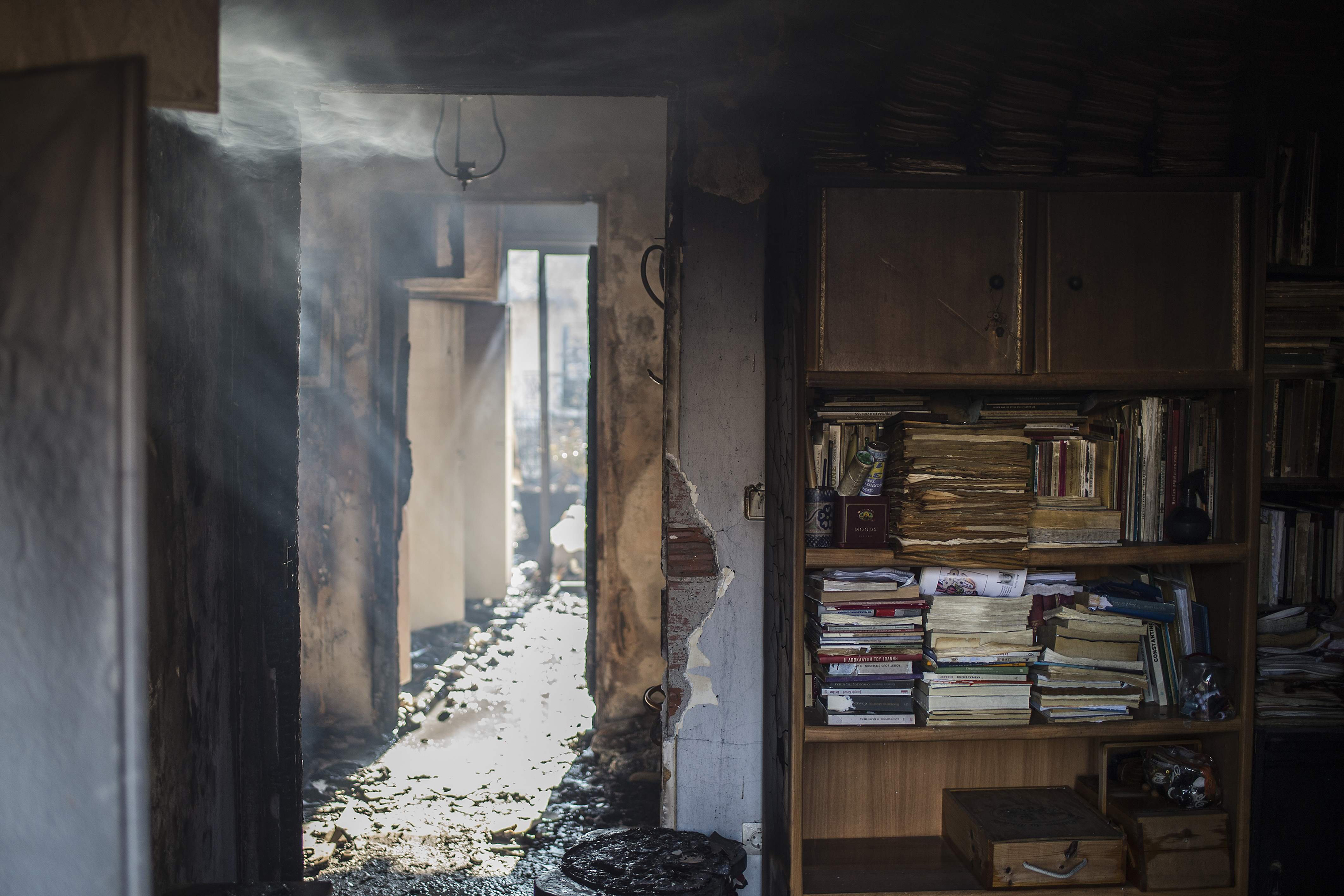 Books inside a burned house in the village of Neos Voutzas, near Athens, on July 25, 2018. (Angelos Tzortzinis—AFP/Getty Images)
