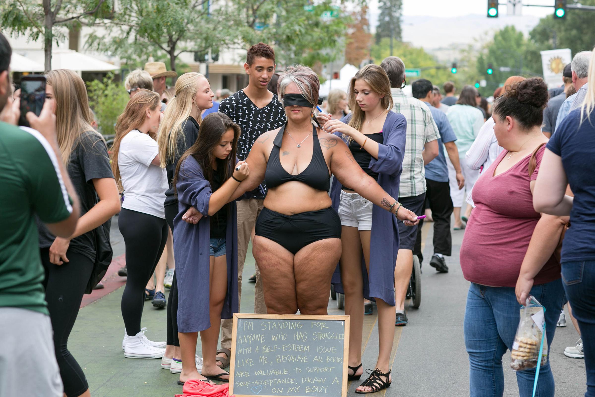 Body image activist Amy Pence-Brown participating in her "self-love performance art piece" in Capital City Public Market in Boise, Idaho on Aug. 29, 2015