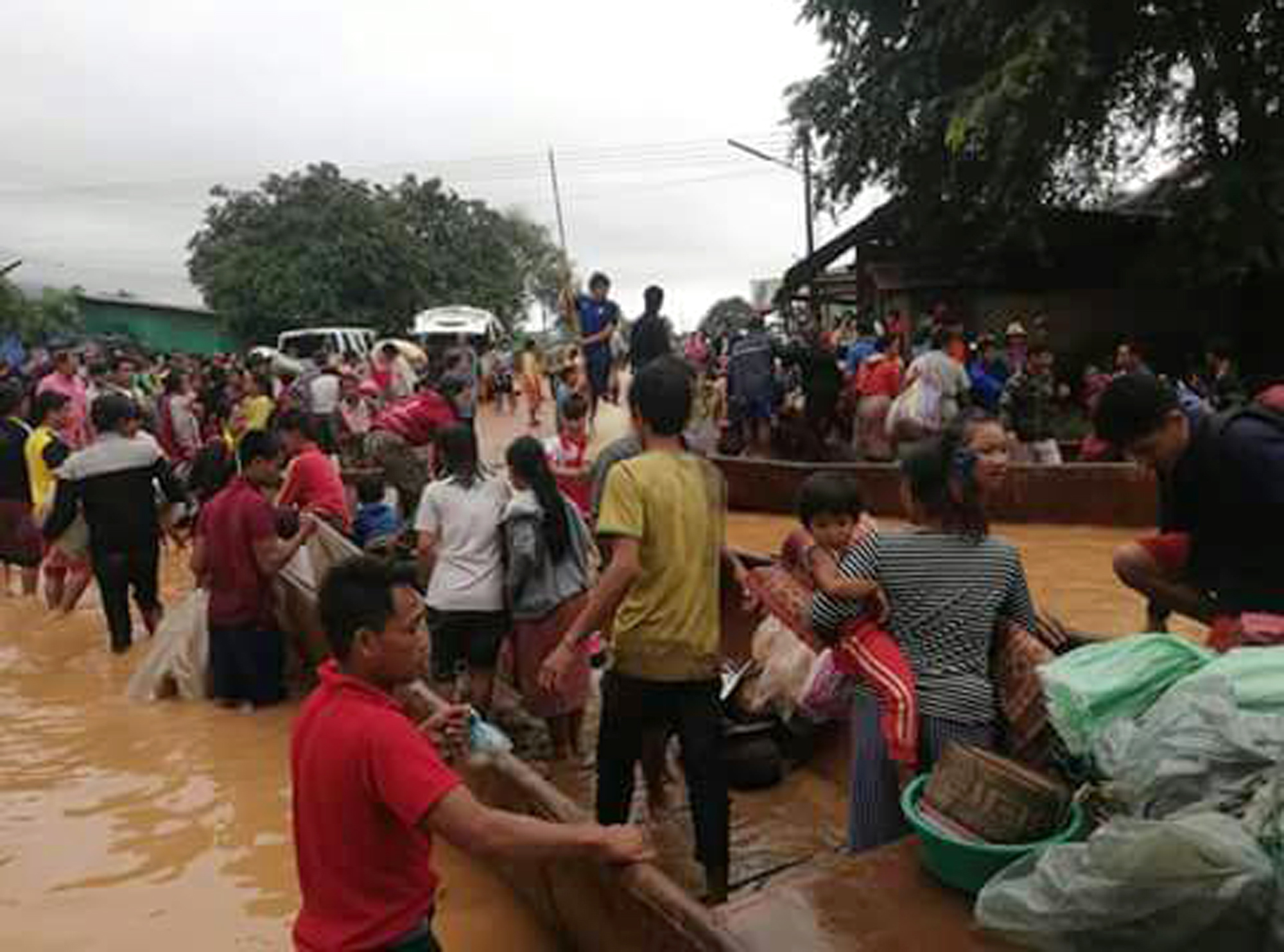 People are evacuated on July 24, 2018 after a dam collapsed in Laos. (Attapeu TV/AP)