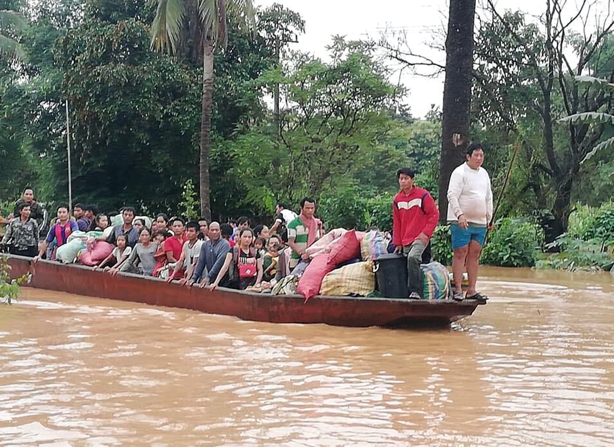 People are evacuated by boat after a dam failed in southeastern Laos. (Attapeu Today/AP)