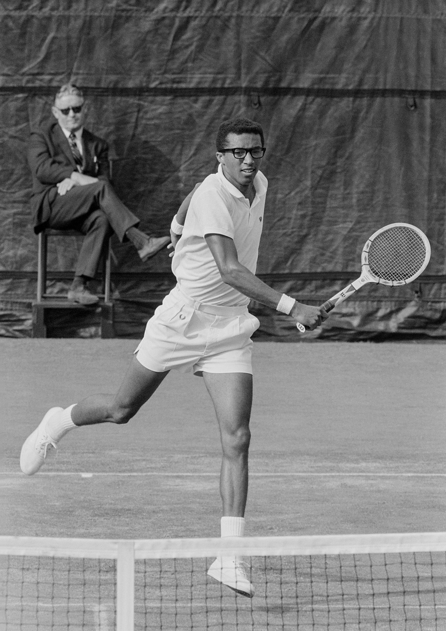 American tennis player Arthur Ashe (1943 - 1993) playing in the US Open final against Tom Okker of the Netherlands. West Side Tennis Club, Forest Hills, New York, September 9, 1968. Photographer John G. Zimmerman