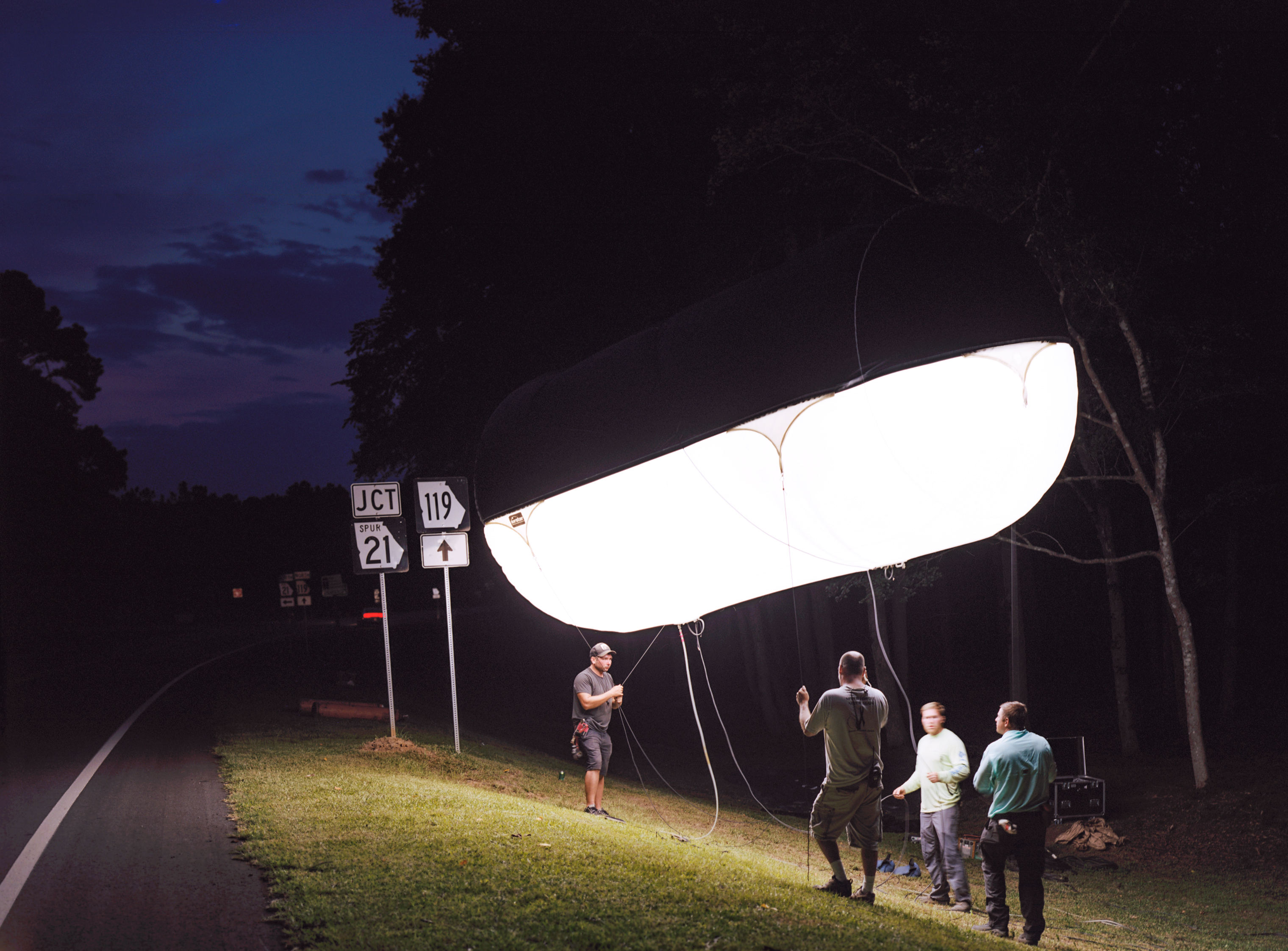 The crew adjusts a lighting balloon on the set of Emperor in Springfield, Ga. (RaMell Ross for TIME)