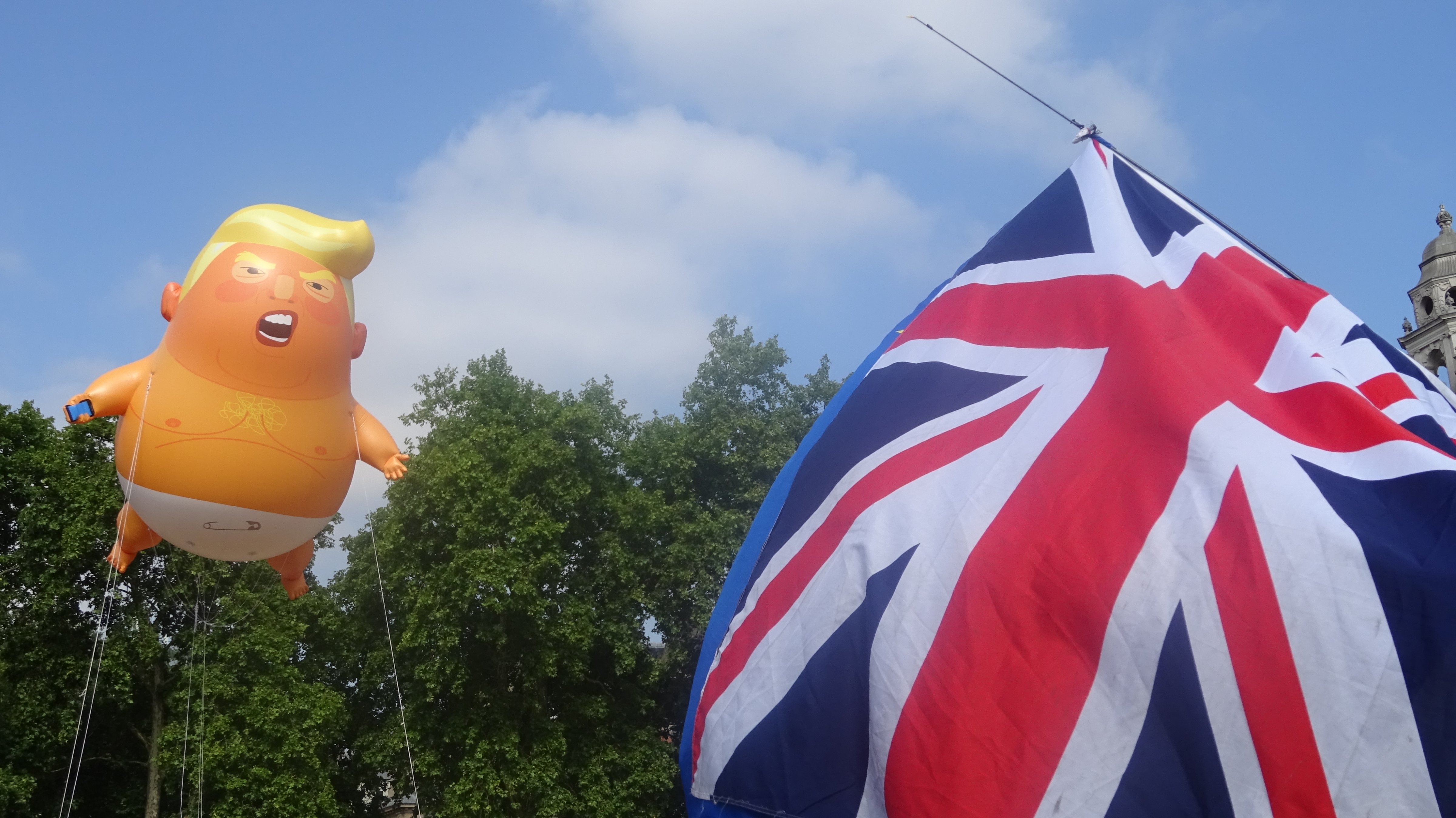 A balloon depicting Trump as an angry orange baby flies in Parliament Square, central London (Billy Perrigo - TIME)