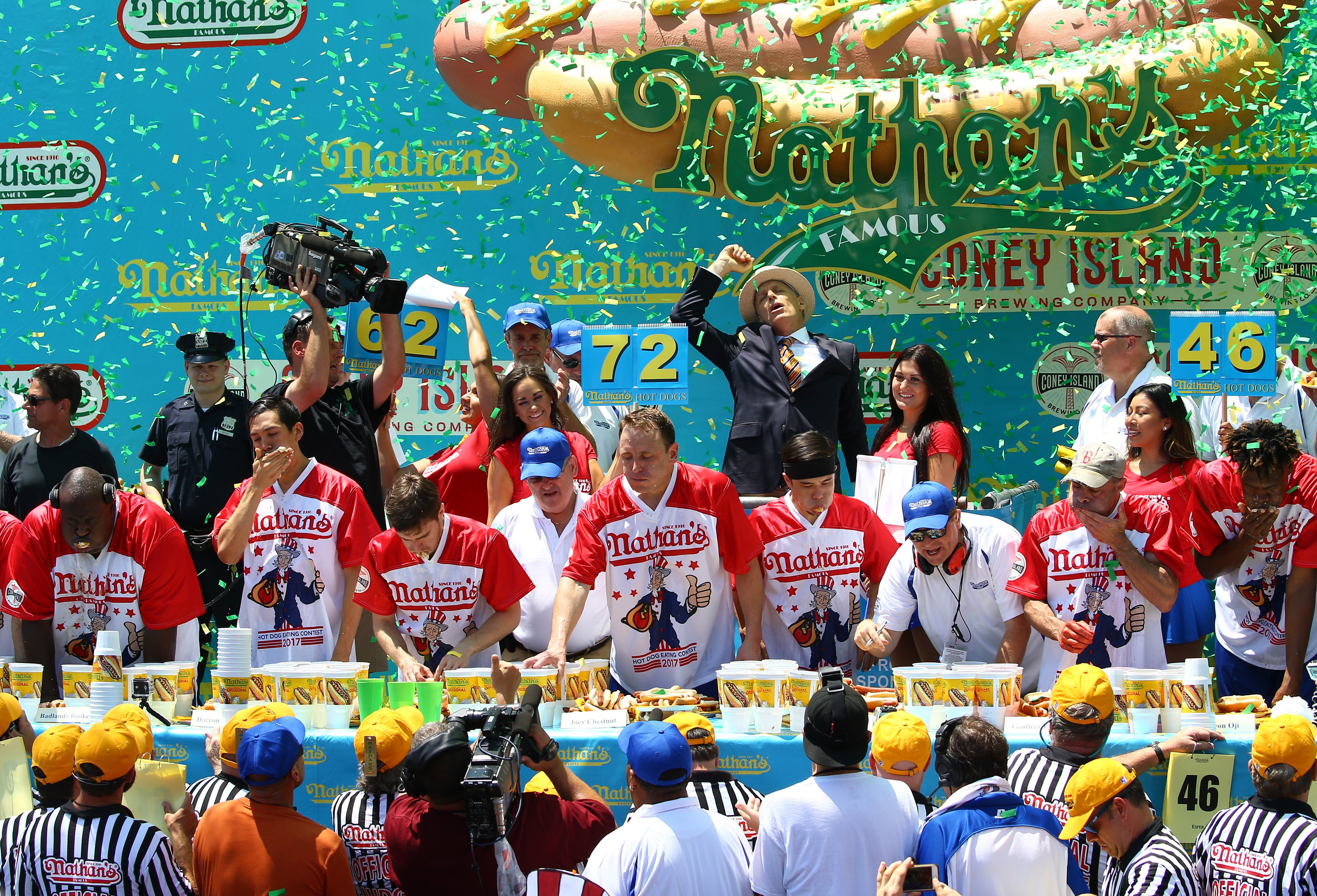 Joey Chestnut (center) wins the men's division of the 2017 Nathan's Famous International Hot Dog Eating Contest at Coney Island, eating 72 hot dogs. (Getty Images)