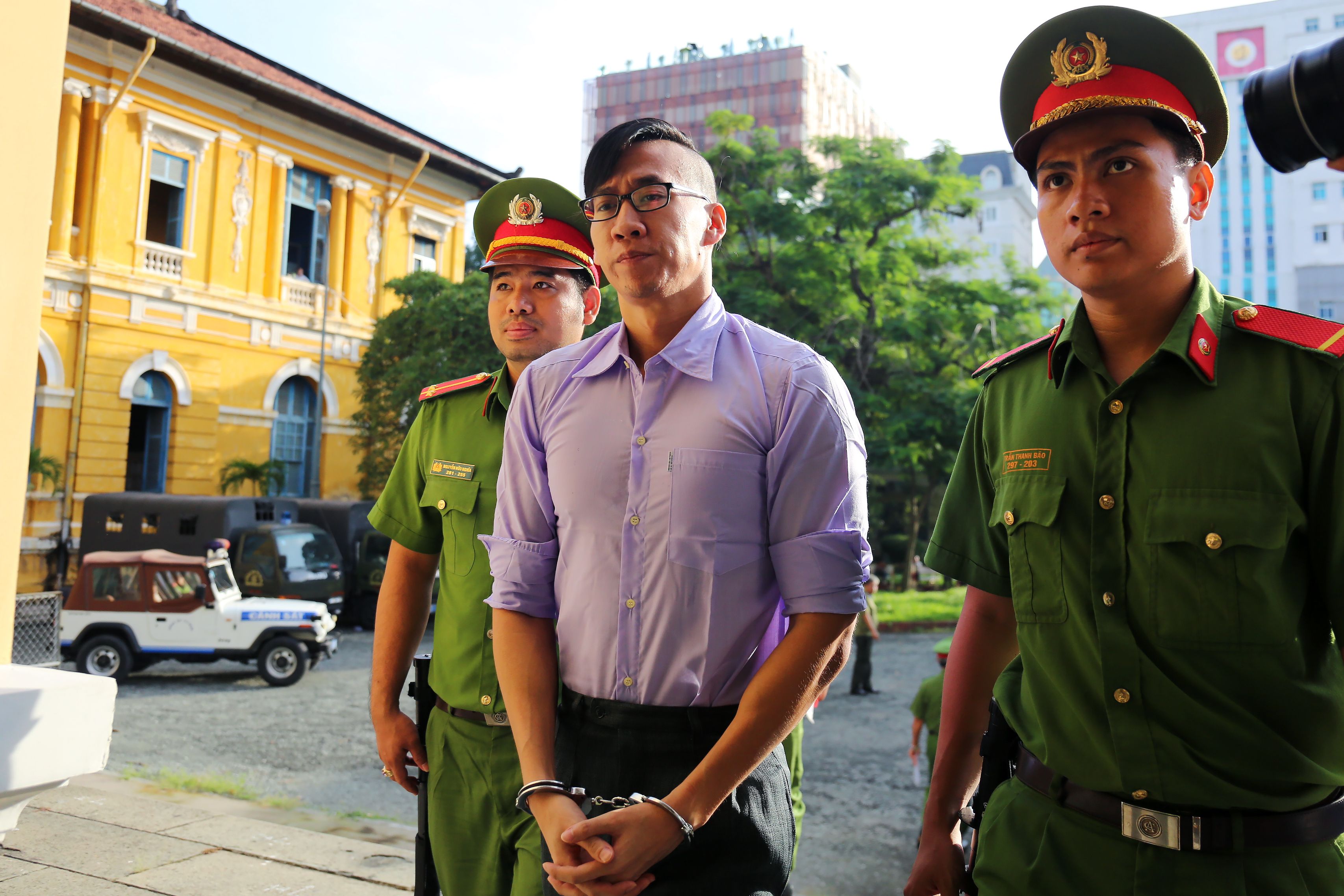 American-Vietnamese citizen William Nguyen is escorted by policemen to a courtroom for his trial in Ho Chi Minh City on July 20, 2018. (AFP—Getty Images)