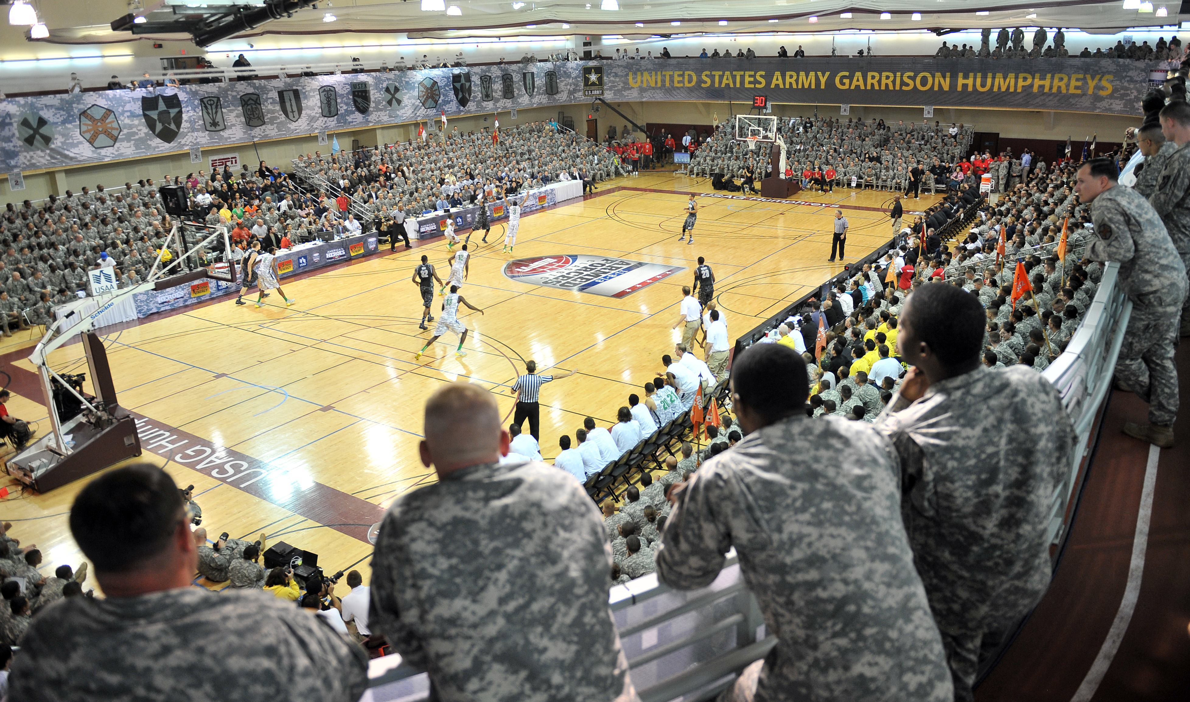 US soldiers watch a game during the Armed Forces Classic of the US college basketball at Camp Humphreys in Pyeongtaek, November 9, 2013. (Jung Yeon-Je—AFP/Getty Images)