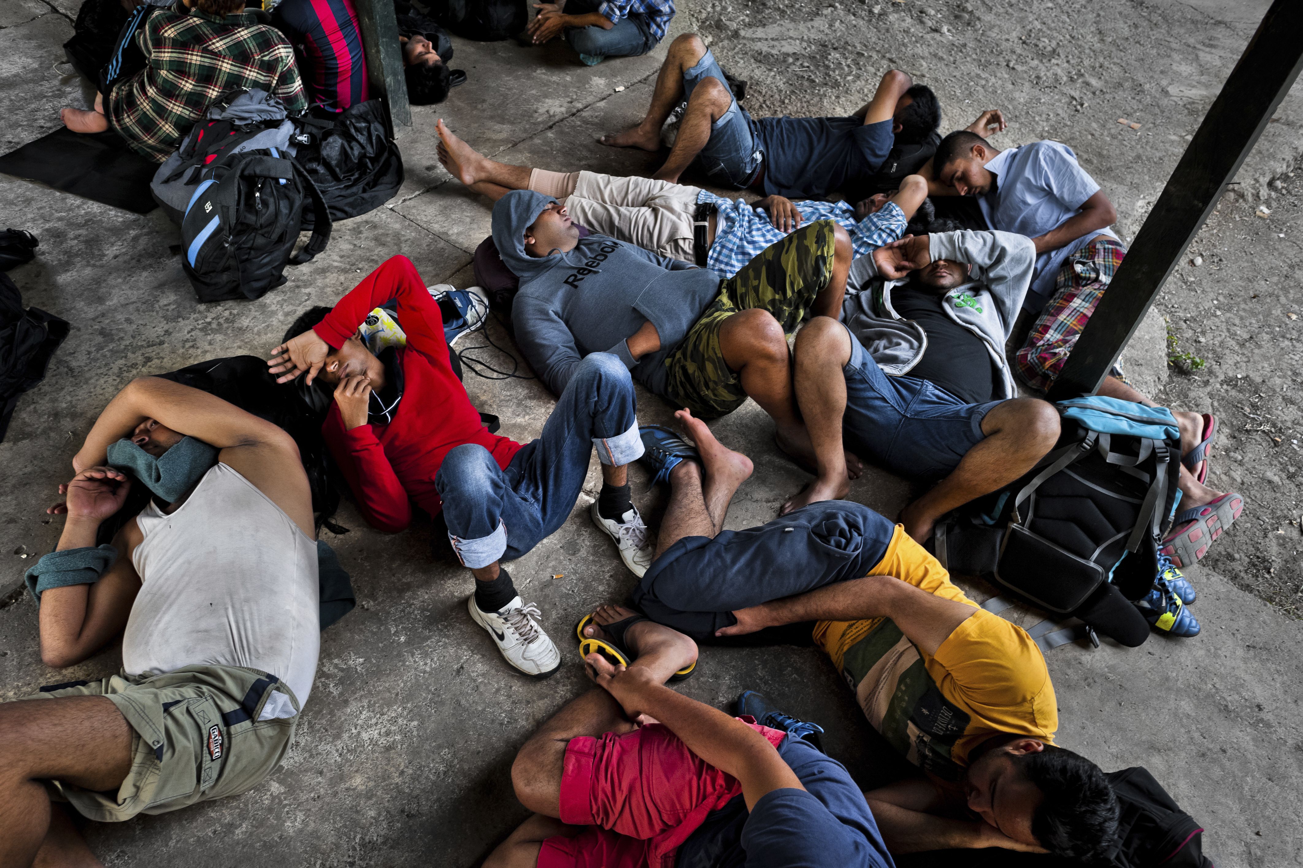 Nepalese immigrants, heading to the southern U.S. border, lie exhausted on the ground in the border checkpoint after crossing the jungle of Darién gap on January 28, 2015 in Darien, Panama. (Jan Sochor—LatinContent/Getty Images)