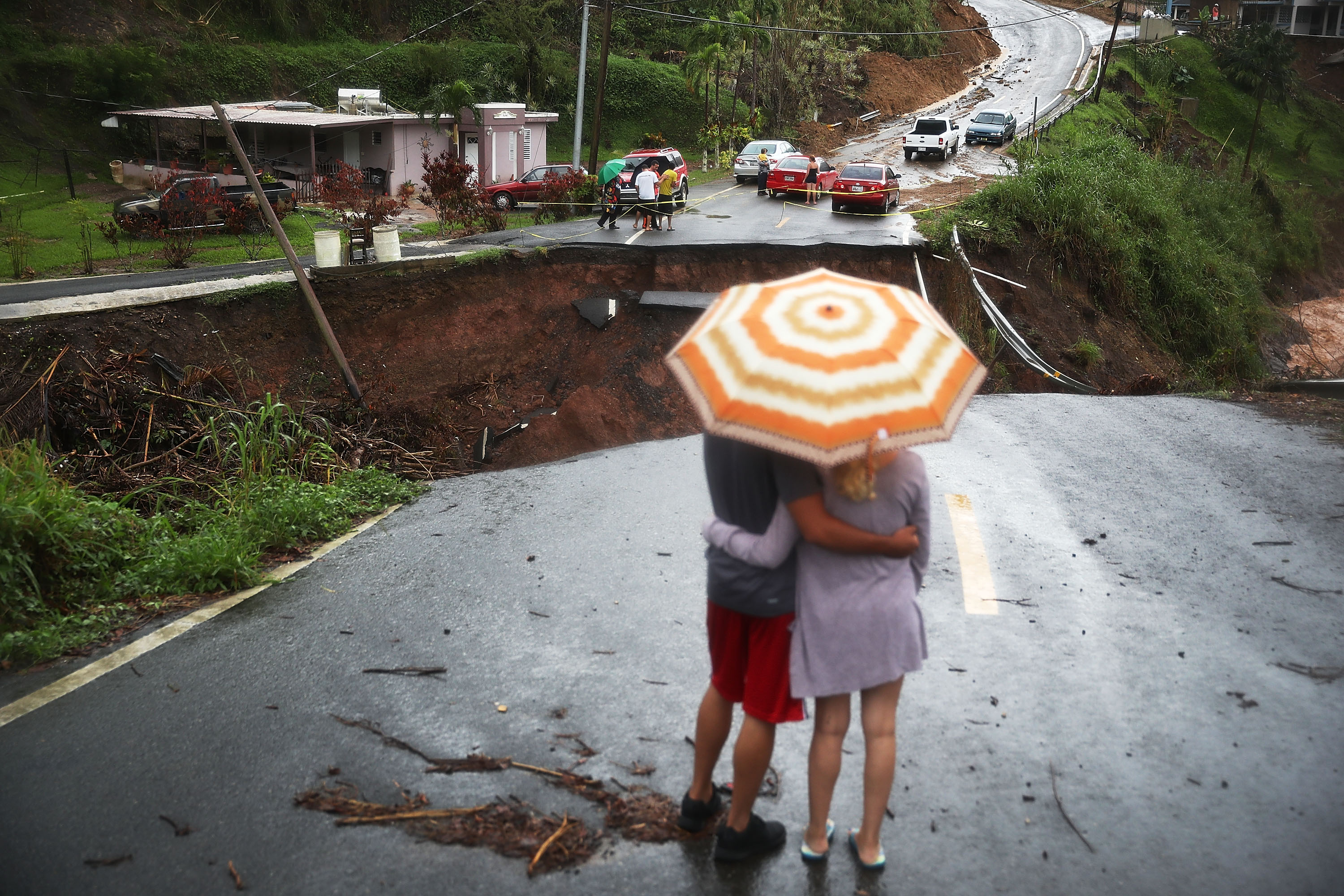 People look at a collapsed road after Hurricane Maria swept through Puerto Rico. (Joe Raedle&mdash;Getty Images)