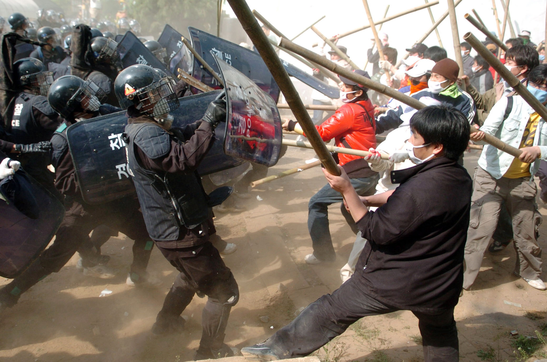 South Korean riot police break up a protest in Pyeongtaek, South Korea, near the U.S. military facility Camp Humphreys, on May 4, 2006. (Seokyong Lee—Bloomberg/Getty Images)
