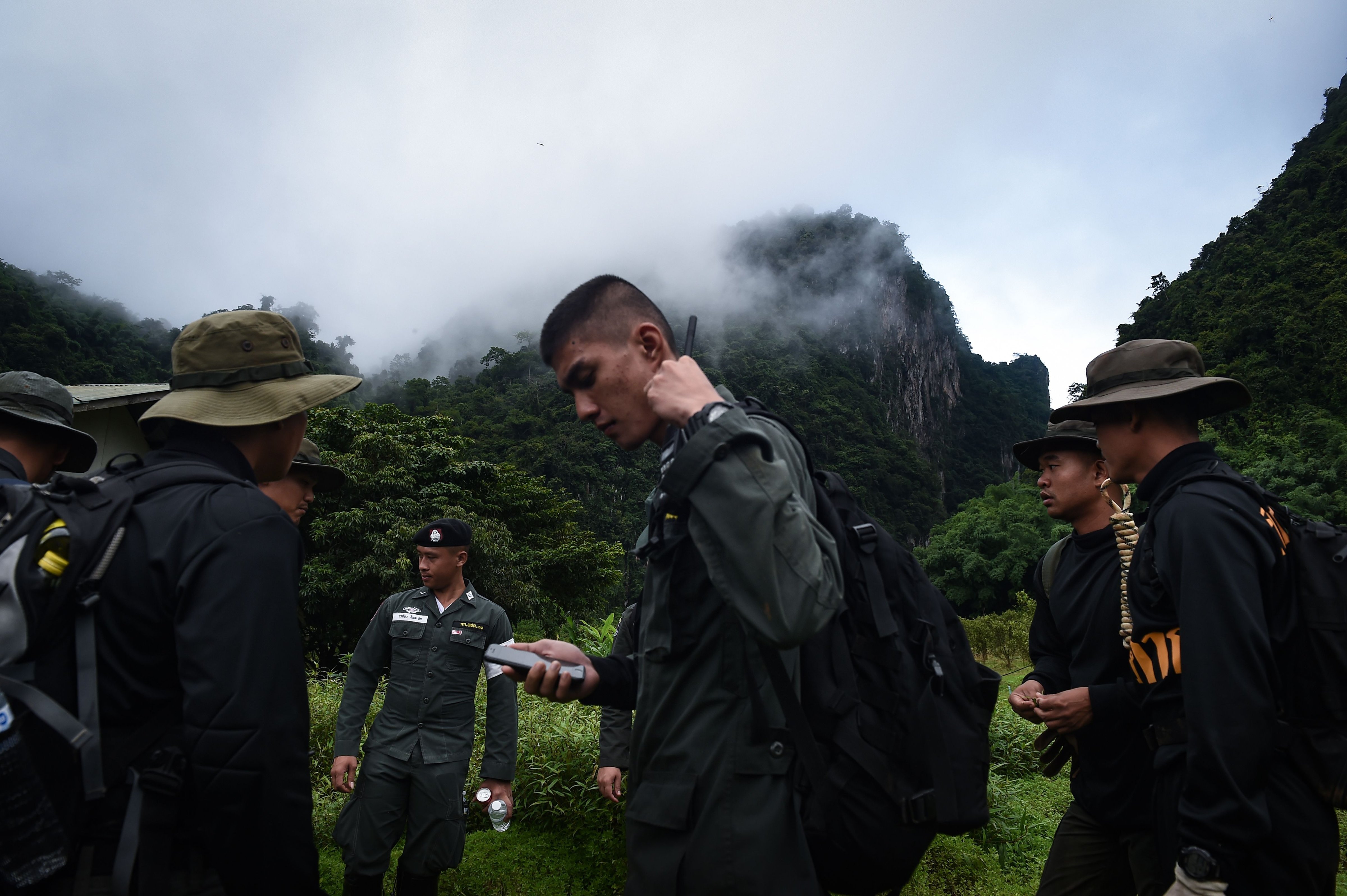 Thai soldiers and police gather in the mountains near the Tham Luang cave at the Khun Nam Nang Non Forest Park in Chiang Rai province on June 30, 2018 as the rescue operation continues for the children of a football team and their coach. (Lillian Suwanrumph—AFP/Getty Images)