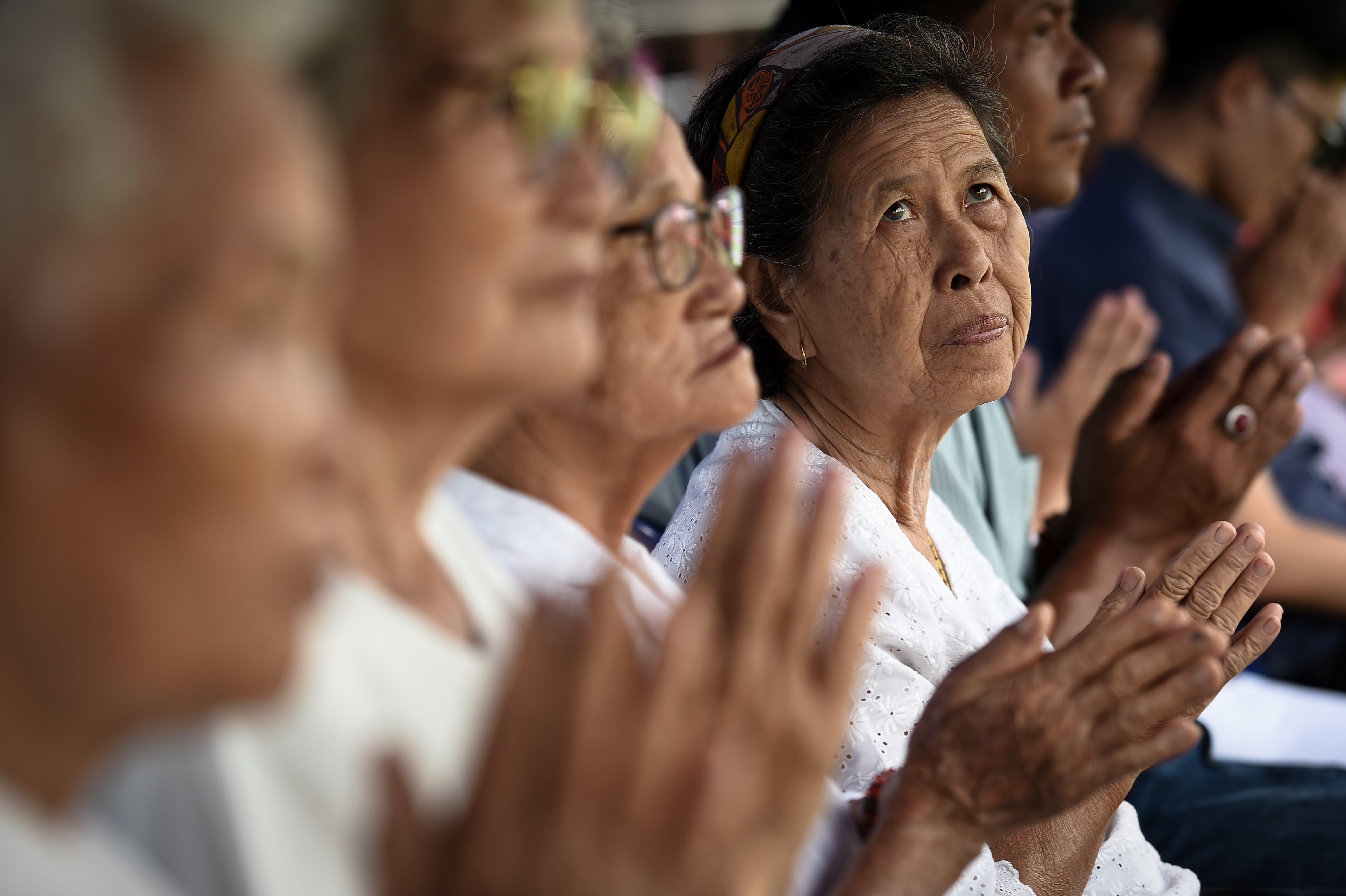 Local women attend a Buddhist prayer for the missing children at a school near Tham Luang cave at the Khun Nam Nang Non Forest Park in the Mae Sai district of Chiang Rai province on July 1, 2018. (Lillian Suwanrumpha—AFP/Getty Images)