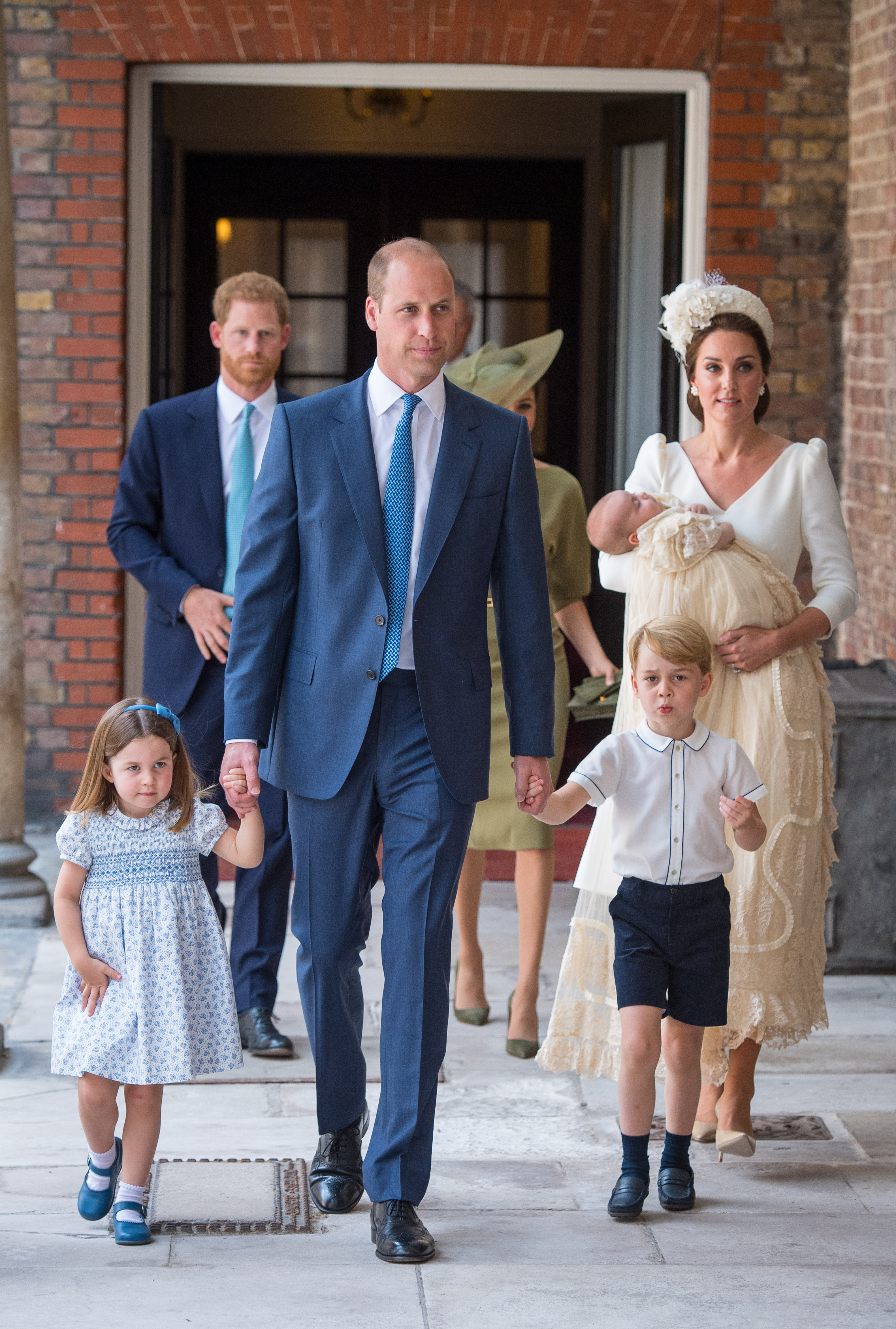 Princess Charlotte and Prince George hold the hands of their father, Prince William, Duke of Cambridge, as they arrive at the Chapel Royal, St James's Palace, London for the christening of their brother, Prince Louis, who is being carried by their mother, Catherine, Duchess of Cambridge on July 09, 2018 in London, England. (Photo by Dominic Lipinski - WPA Pool/Getty Images) (WPA Pool—Getty Images)