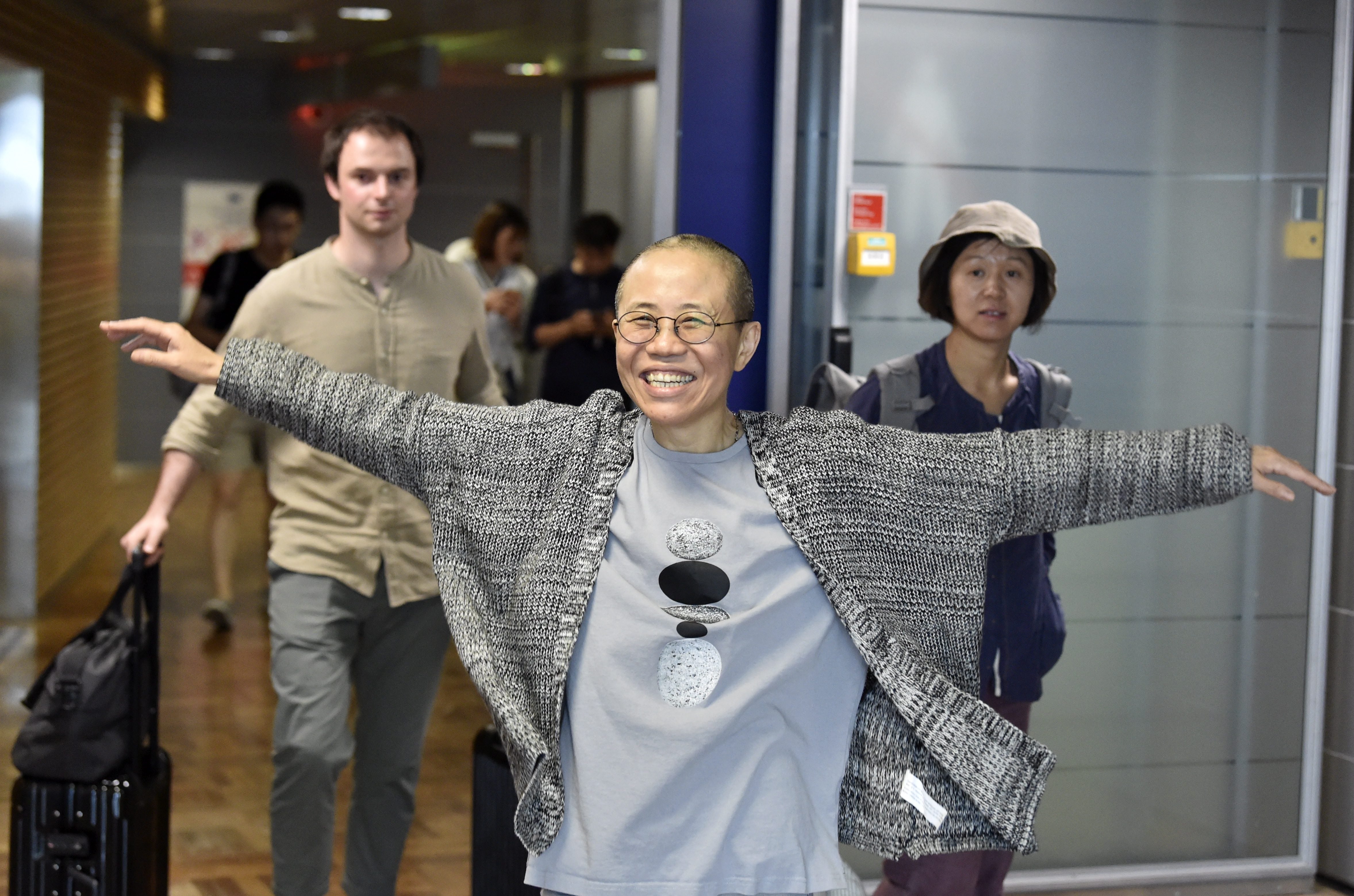 Liu Xia, the widow of Chinese Nobel dissident Liu Xiaobo, smiles as she arrives at the Helsinki International Airport in Vantaa, Finland, on July 10, 2018. (JUSSI NUKARI—AFP/Getty Images)
