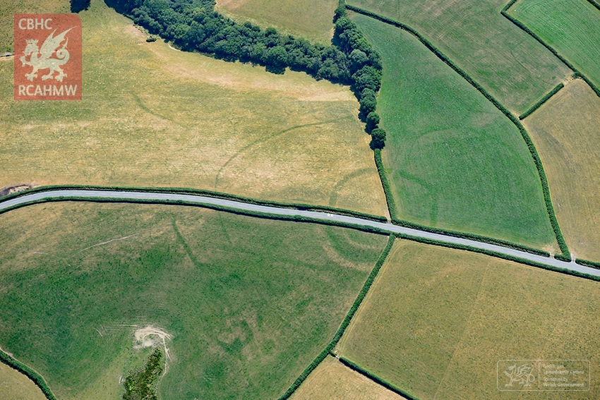An Iron-age farmstead shows up beneath a road and fields in Wales (RCAHMW)