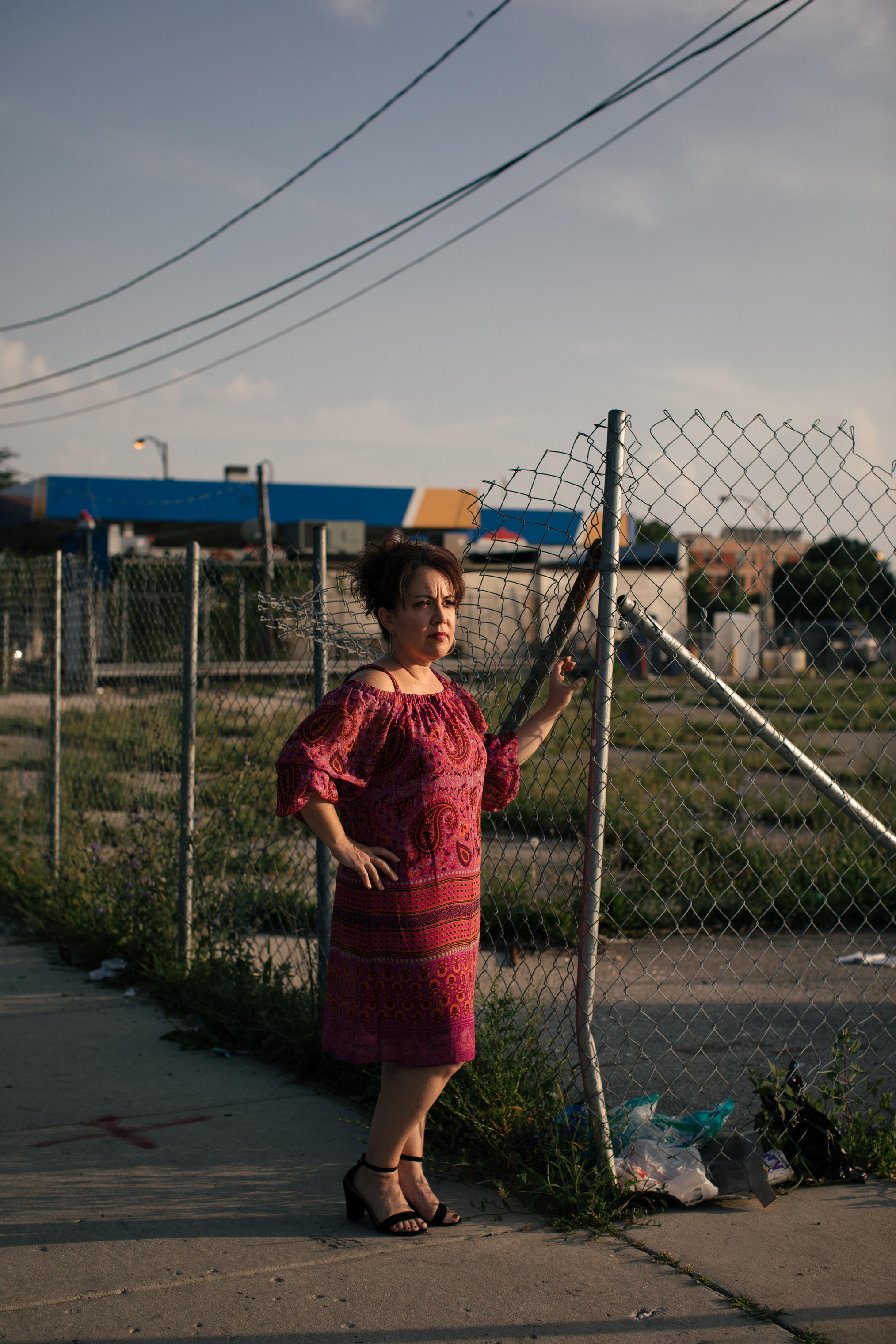 Juanita Irizarry, the Executive Director of Friends of the Parks, poses next to empty lots adjacent to Washington Park on Chicago's South Side. Several lots in the area are empty, and businesses, like the Amstar gas station, could be sold to make way for the Obama Presidential Center. (Alyssa Schukar for TIME)